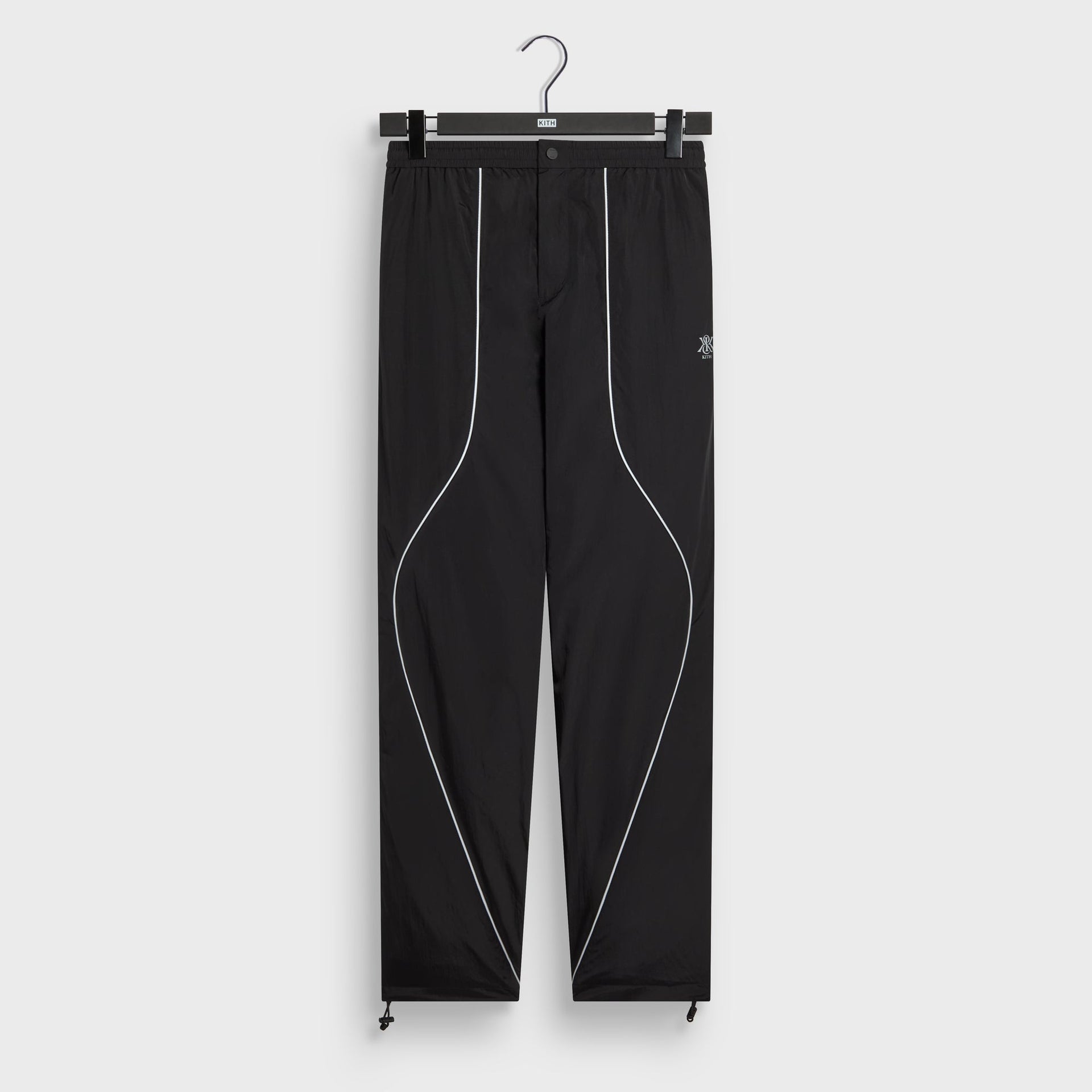 Kith Seamed Nylon Bolt pant in black with reflective piping, front flat lay
