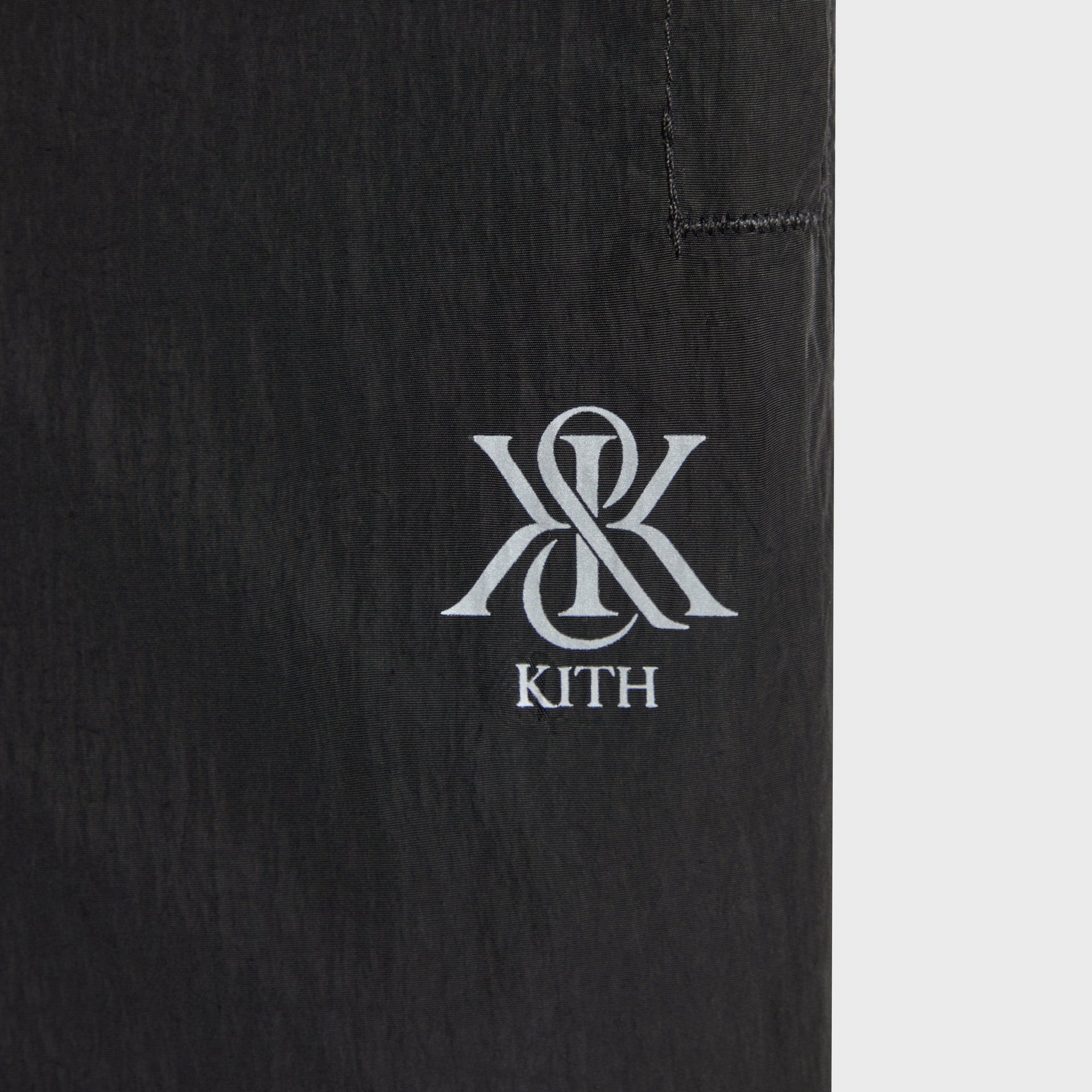 Close-up of the embroidered ampersand K logo on the pocket of the Kith Nylon Bolt pant