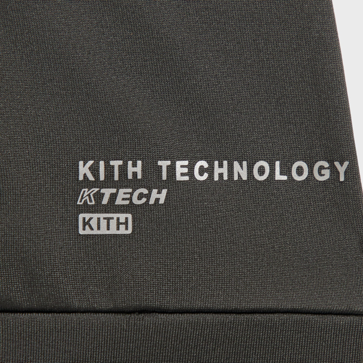 Close-up of the Kith Technology KTECH print on the mesh panel of the balaclava