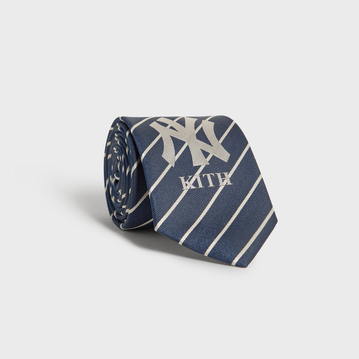 Kith x New York Yankees Nocturnal tie rolled up showing NY Kith logo on pinstripes