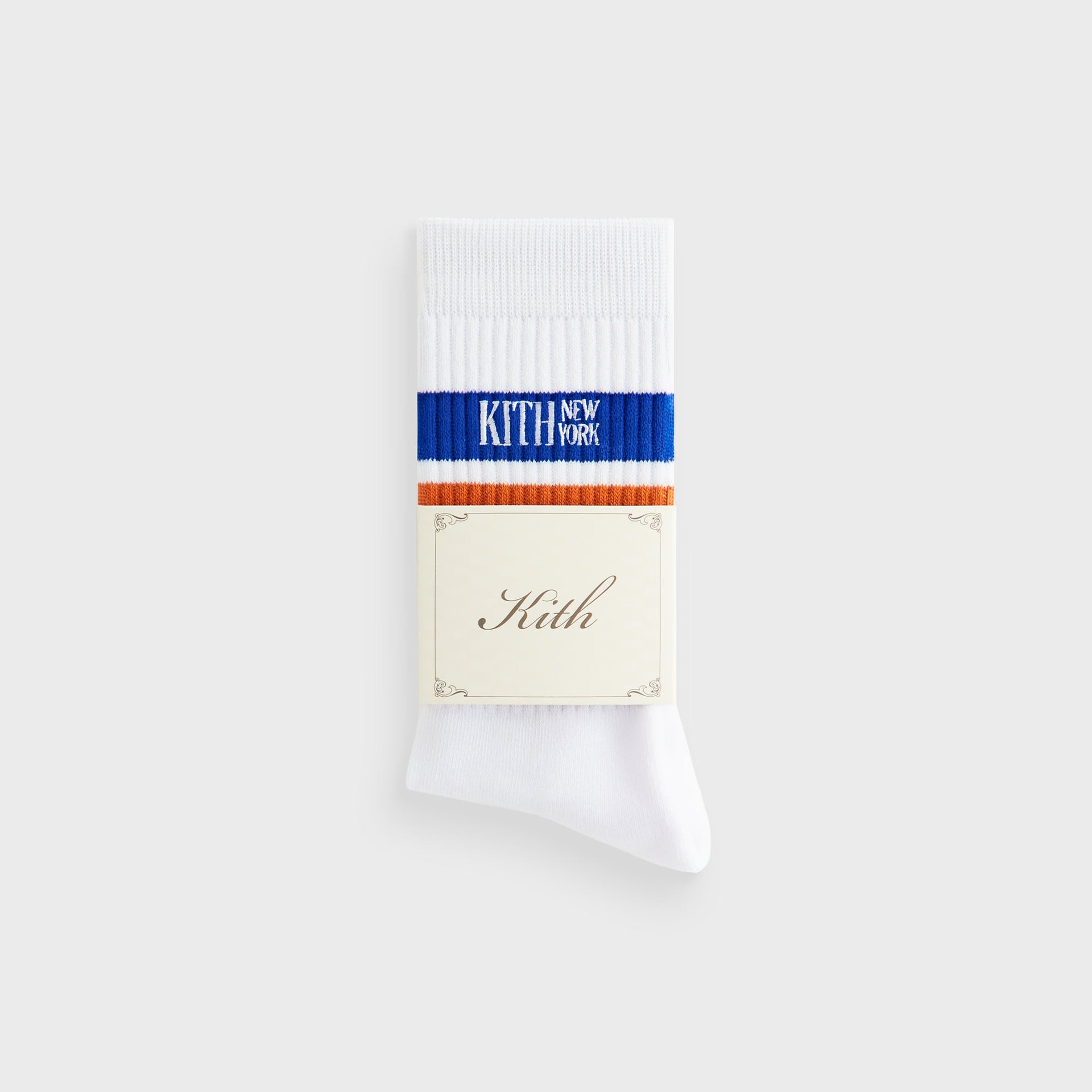 Kith Calf Stripe Socks in white with folded Kith branded paper wrap around the striped cuff