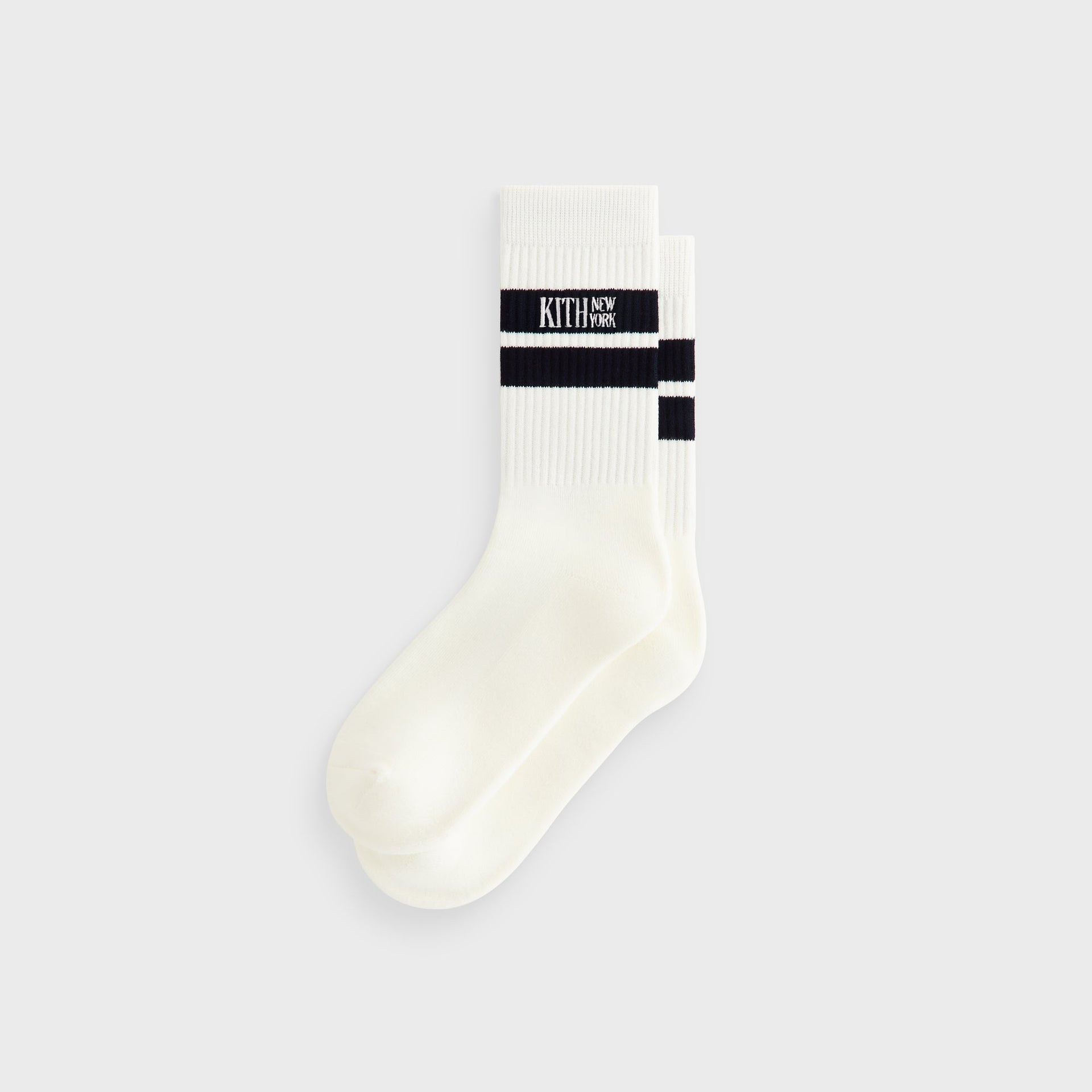 Kith Calf Stripe Socks in Silk, off-white crew sock with navy stripe and Kith New York logo, front flat lay