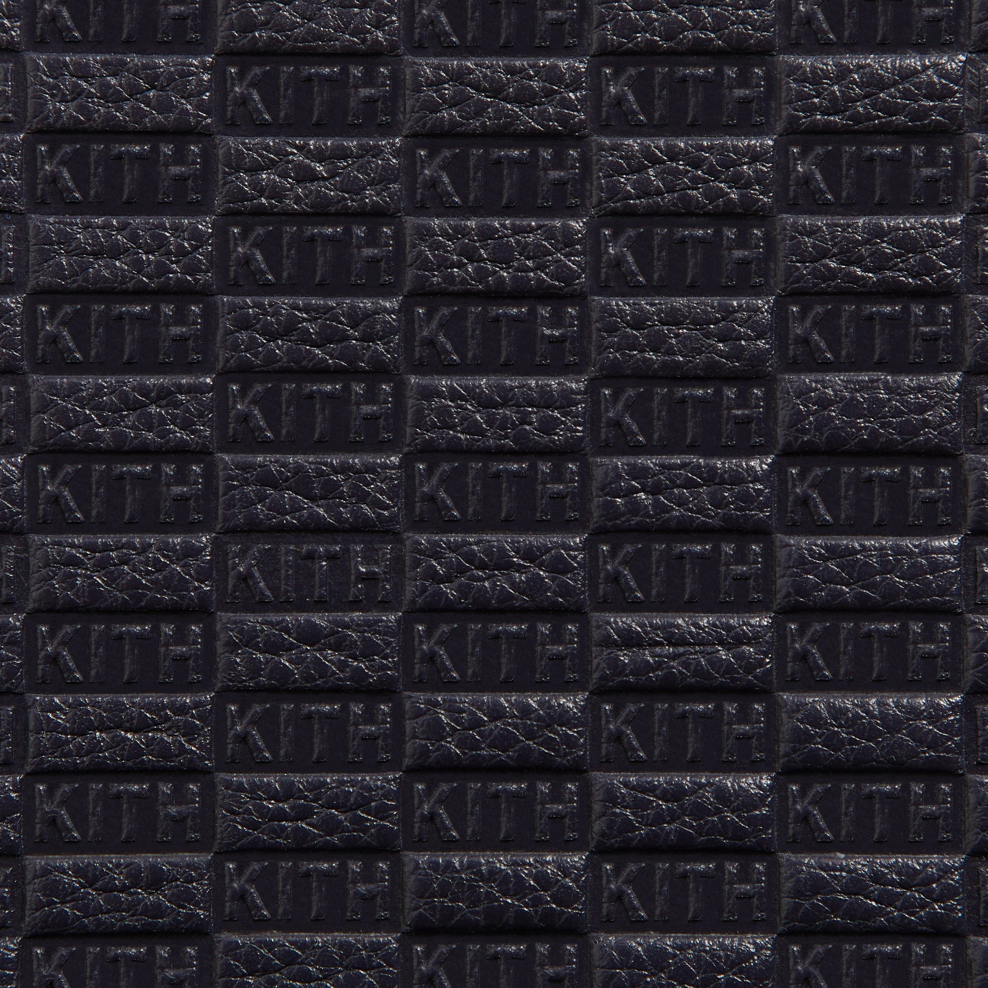 Extreme close-up of embossed KITH monogram pattern on Ink Saffiano leather Watch Box