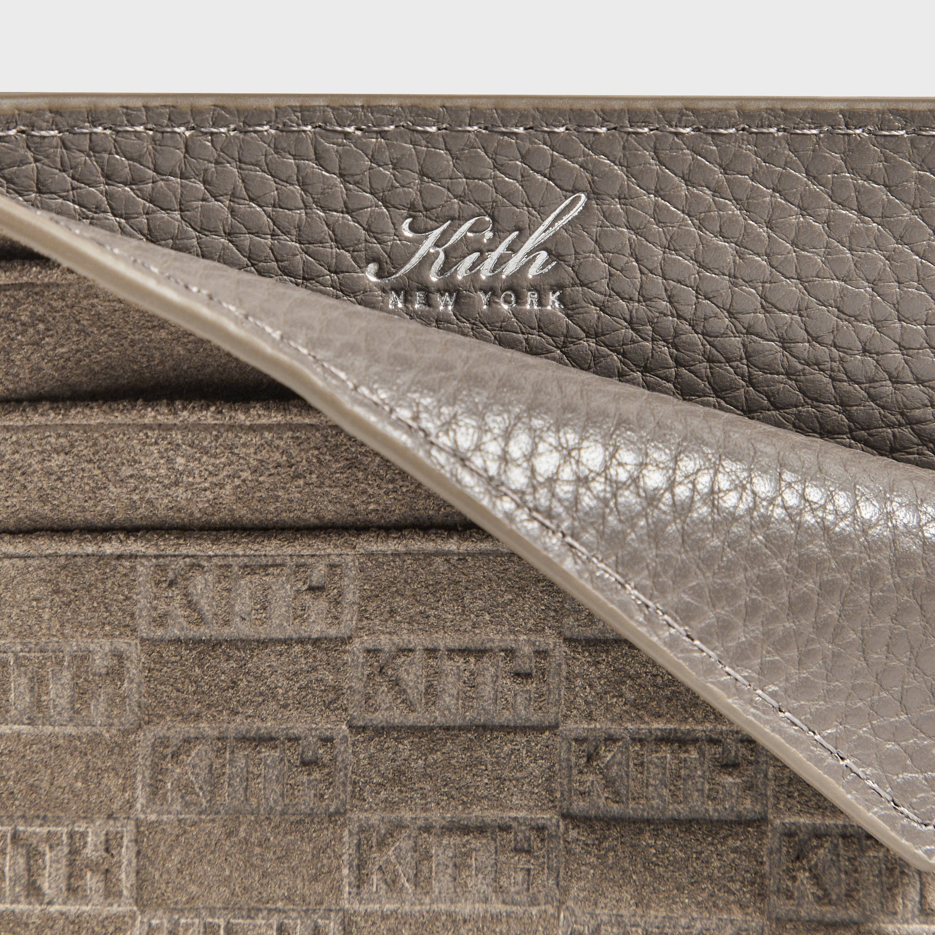 Kith Monogram Suede Cardholder in Java, macro detail of pebbled leather trim with debossed Kith New York logo