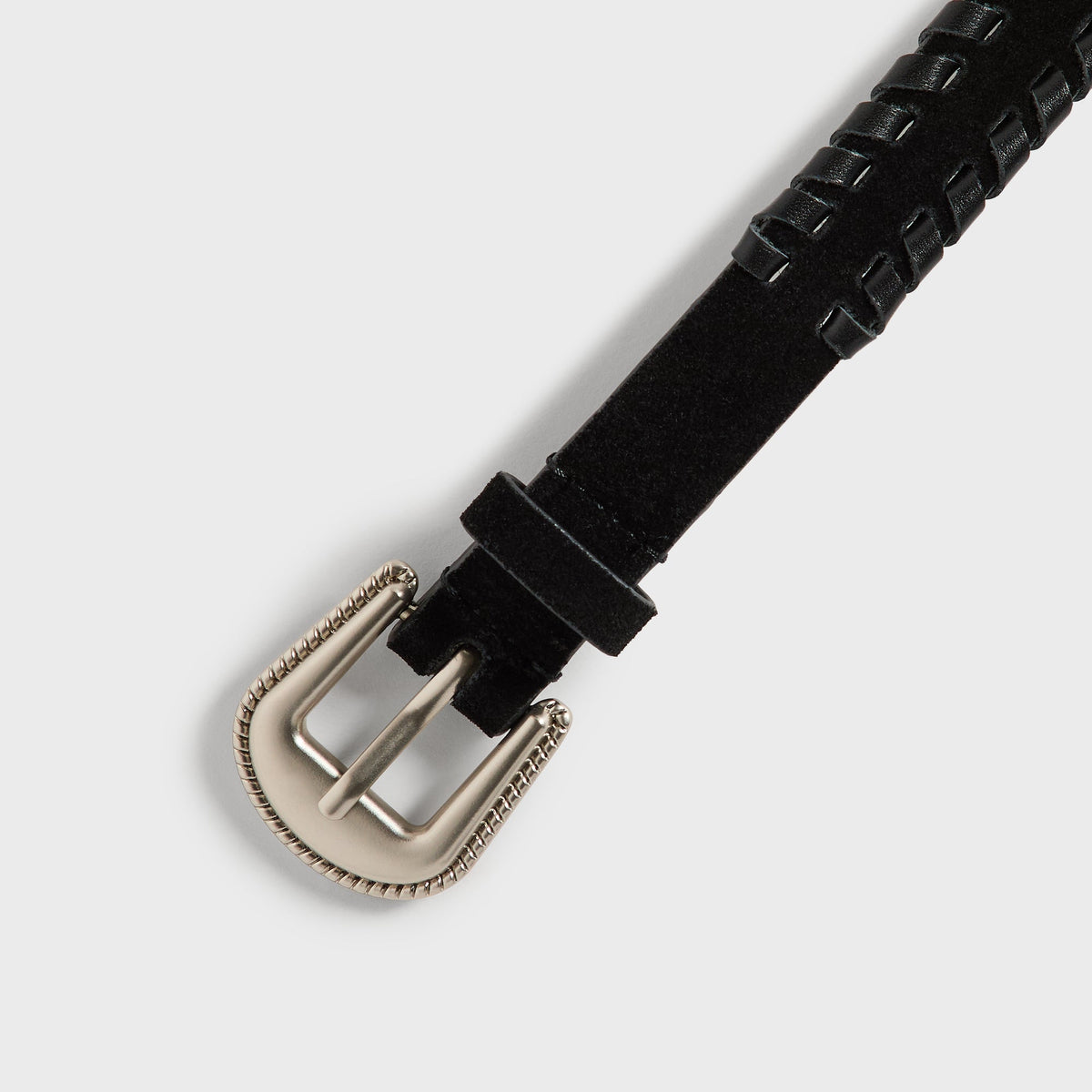 Close-up of silver rope-edge buckle on black suede Kith braided edge belt