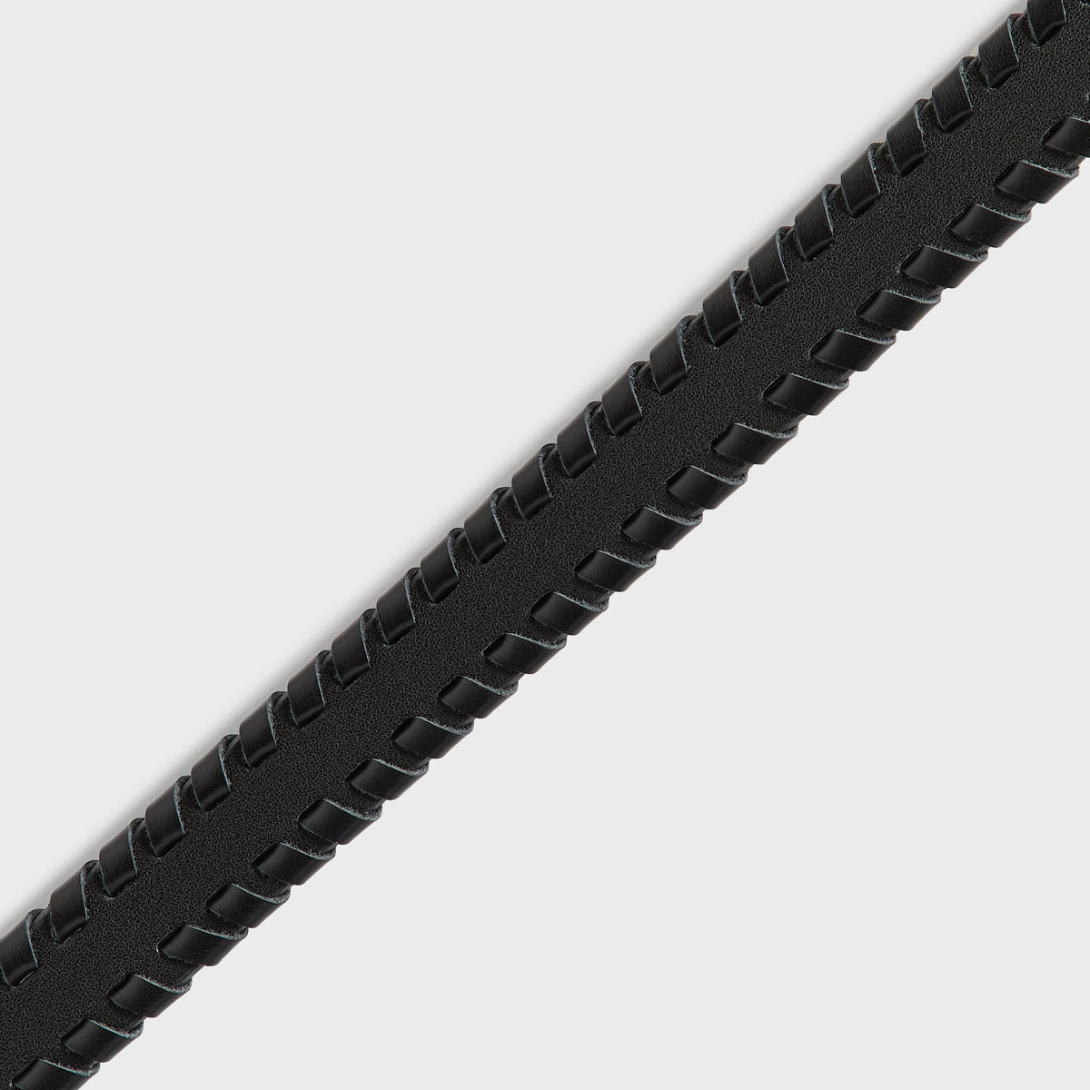 Close-up of woven braided edge detail on black Kith leather belt