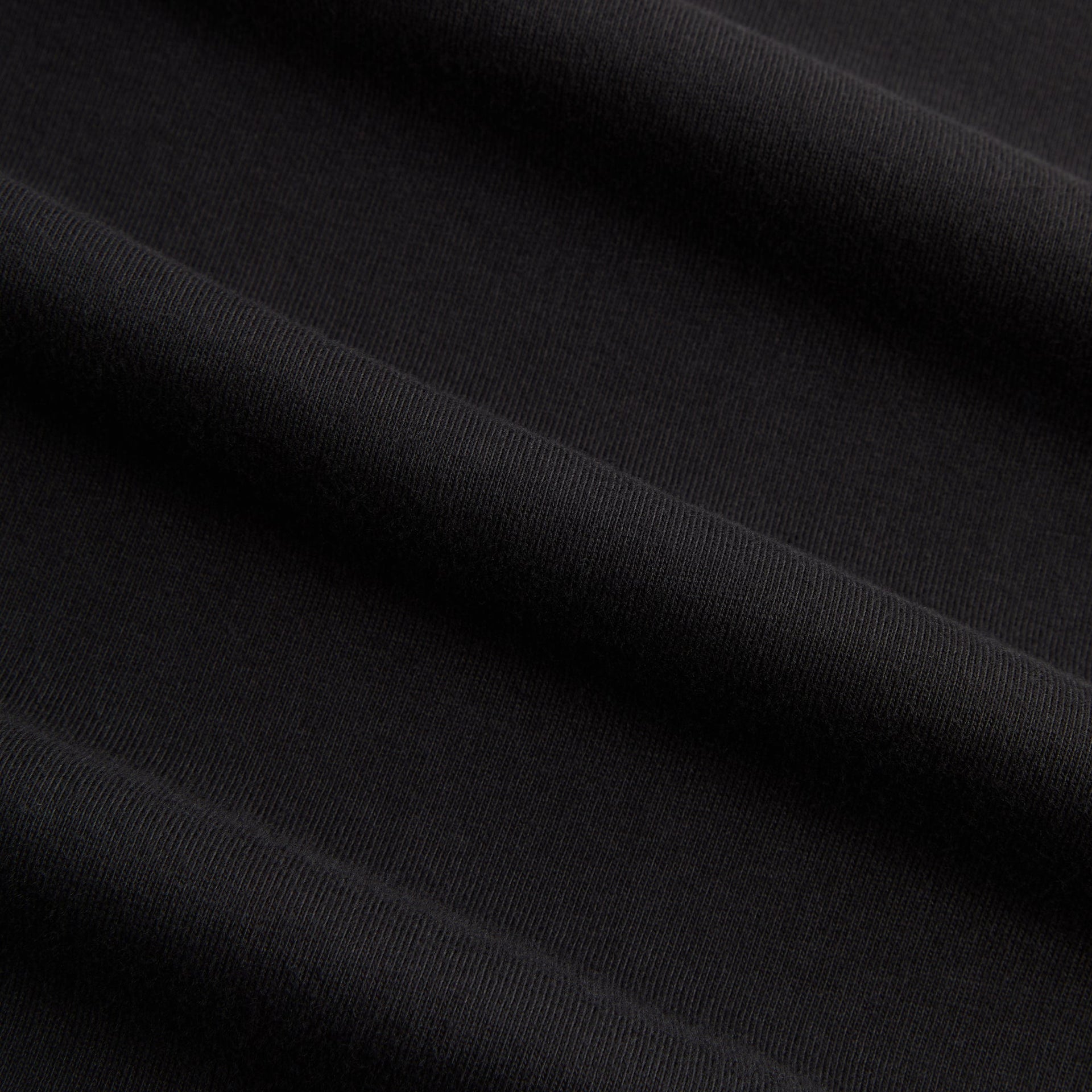 Macro detail of the black cotton jersey fabric of the Kith for Cinelli Ciclismo Tee