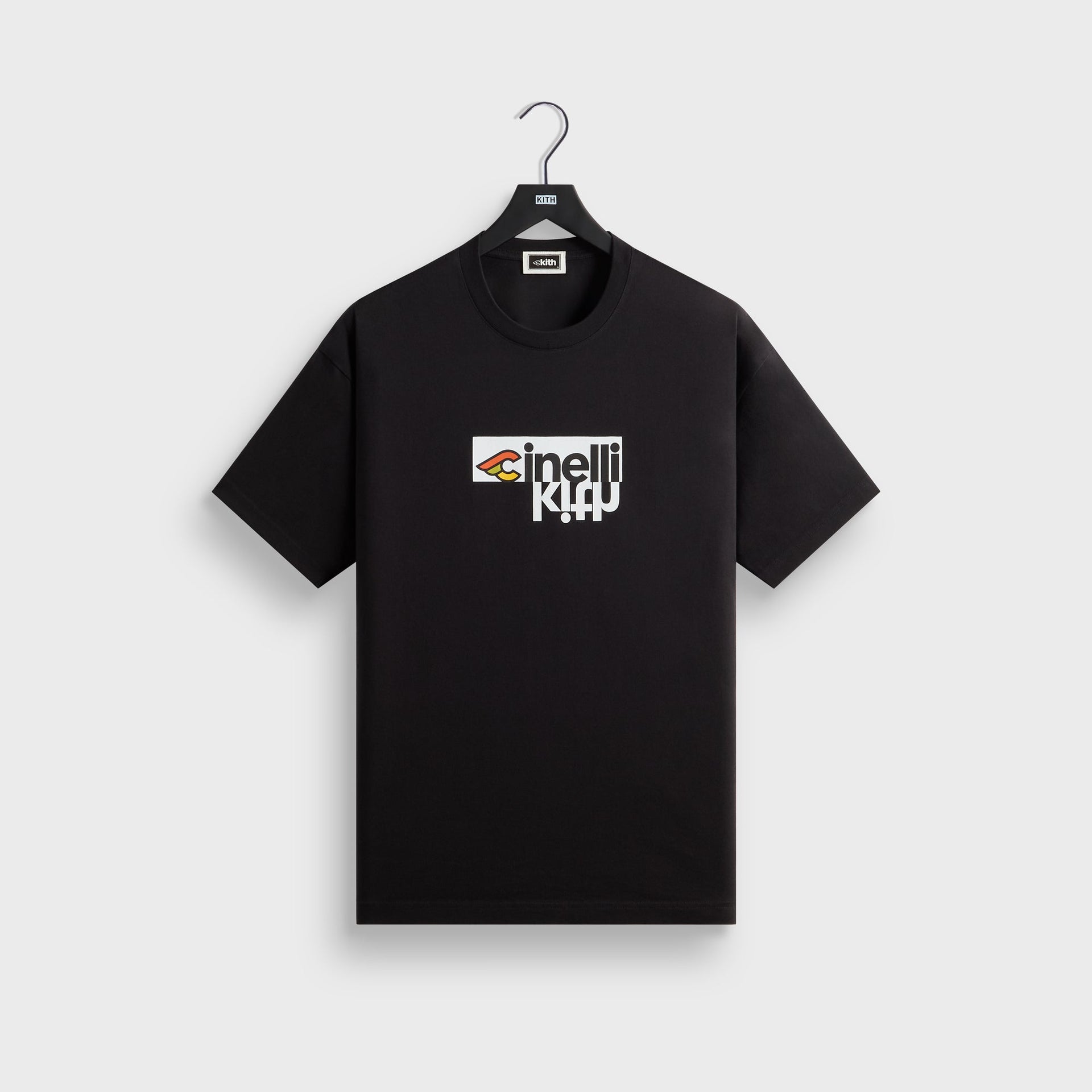 Front of the black Kith for Cinelli Upside Down Tee on a Kith hanger, chest print pairing the Cinelli winged-C logo with an upside-down Kith wordmark