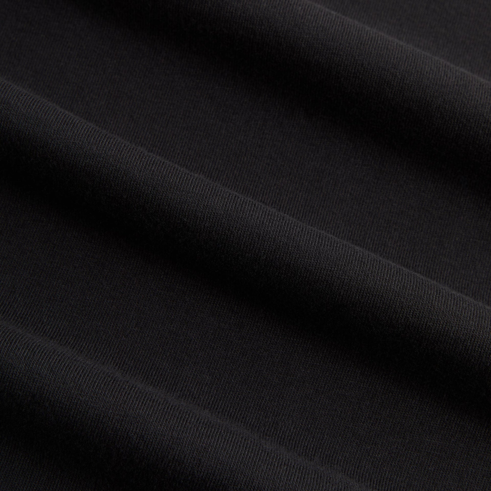 Macro detail of the black cotton jersey fabric of the Kith for Cinelli Upside Down Tee