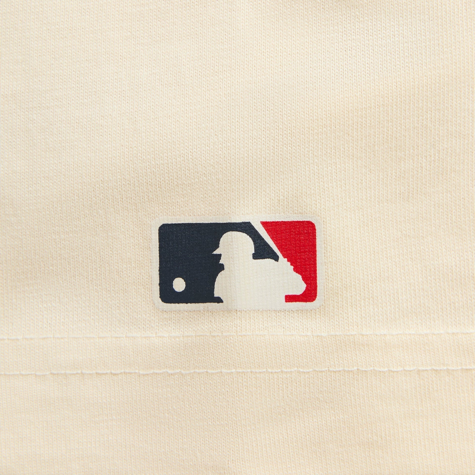 Close-up of MLB logo patch on cream Kith for New York Yankees script tee