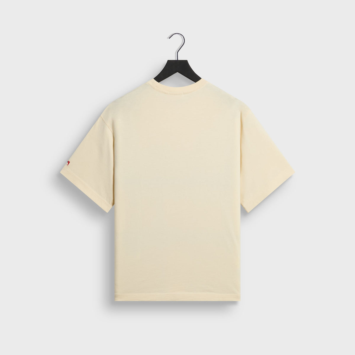 Back of cream Kith for New York Yankees script tee with small red MLB tag detail on sleeve