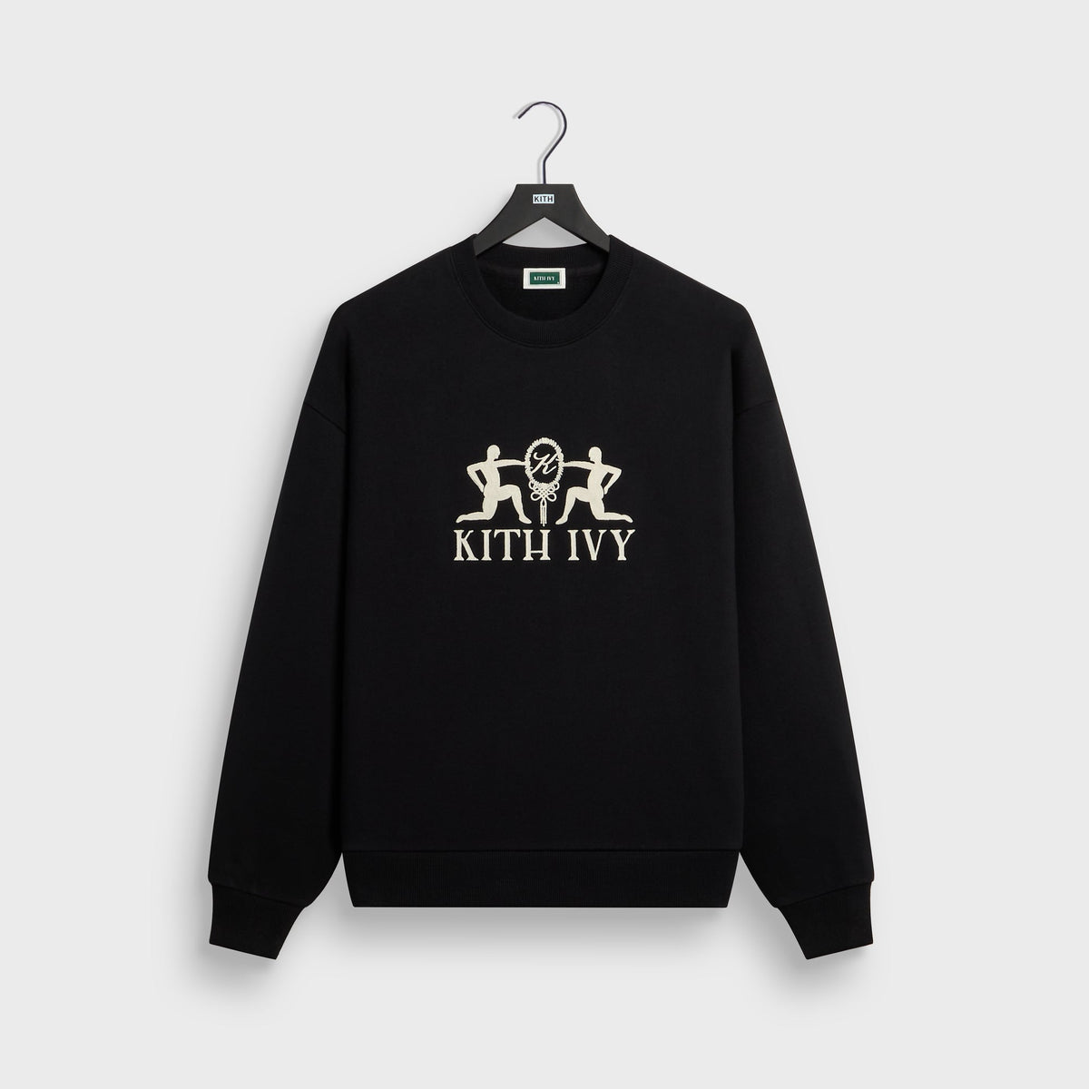 Kith Ivy Emblem Vintage Crewneck in black on hanger, front view with cream embroidered kneeling figures and KITH IVY