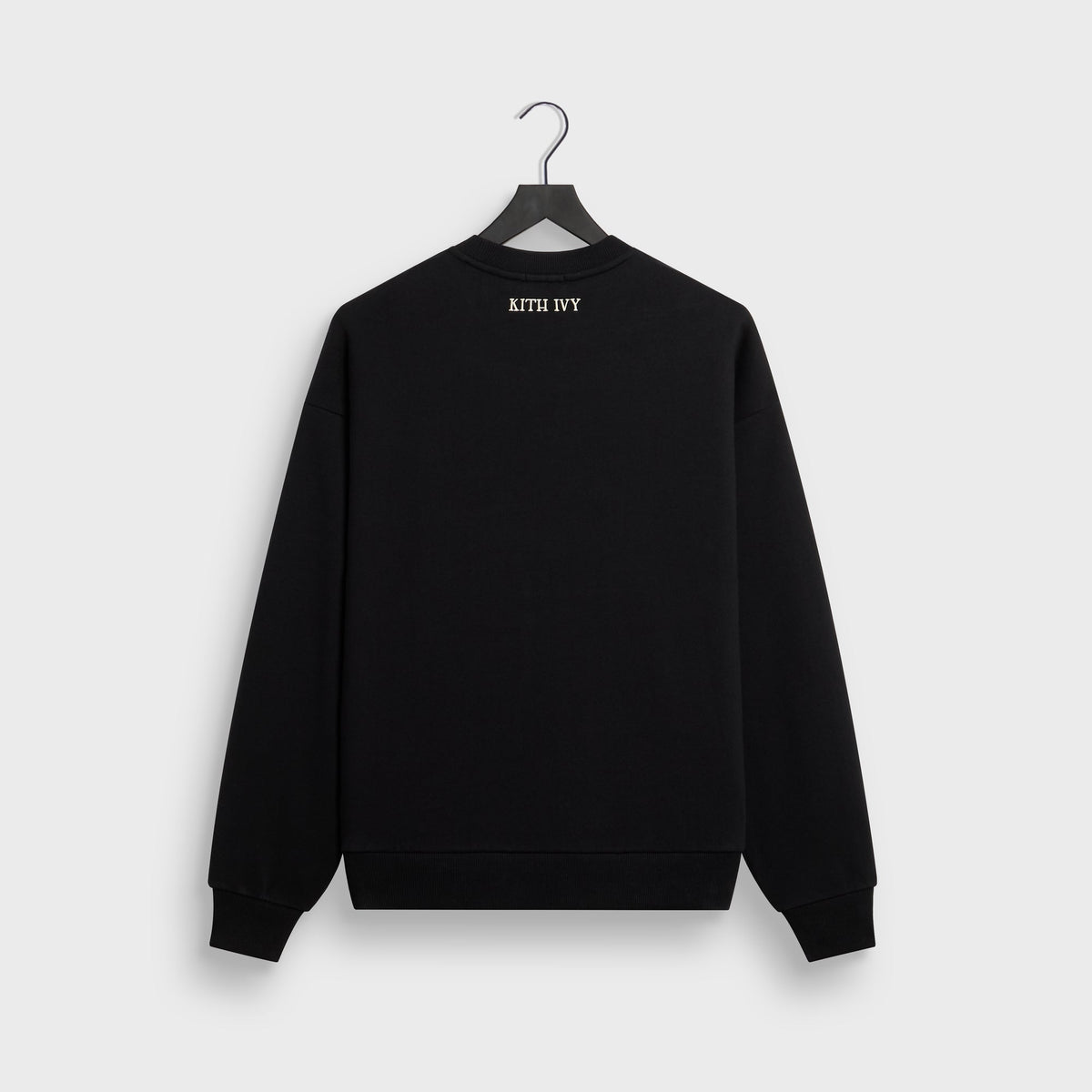 Kith Ivy Emblem Vintage Crewneck in black on hanger, back view with small KITH IVY embroidery at neck