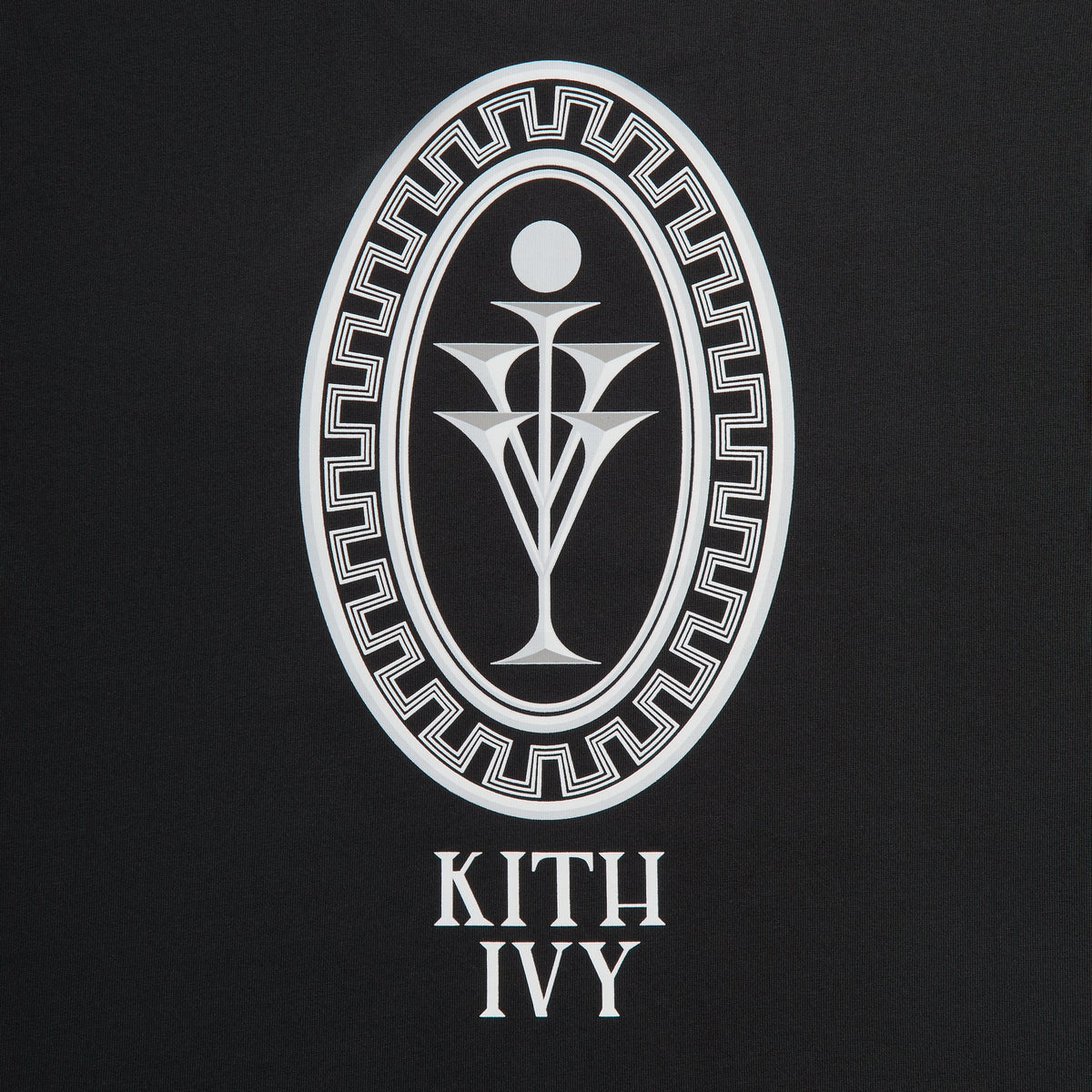 Close-up of white Greek-key oval emblem above KITH IVY text on black tee back, Cafe Mogador collaboration
