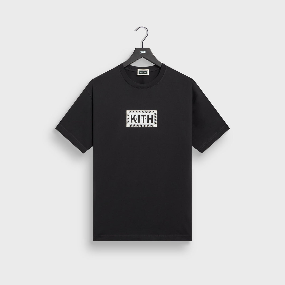 Kith Ivy Classic Logo Tee in black on hanger, front view with cream Greek-key box logo on chest