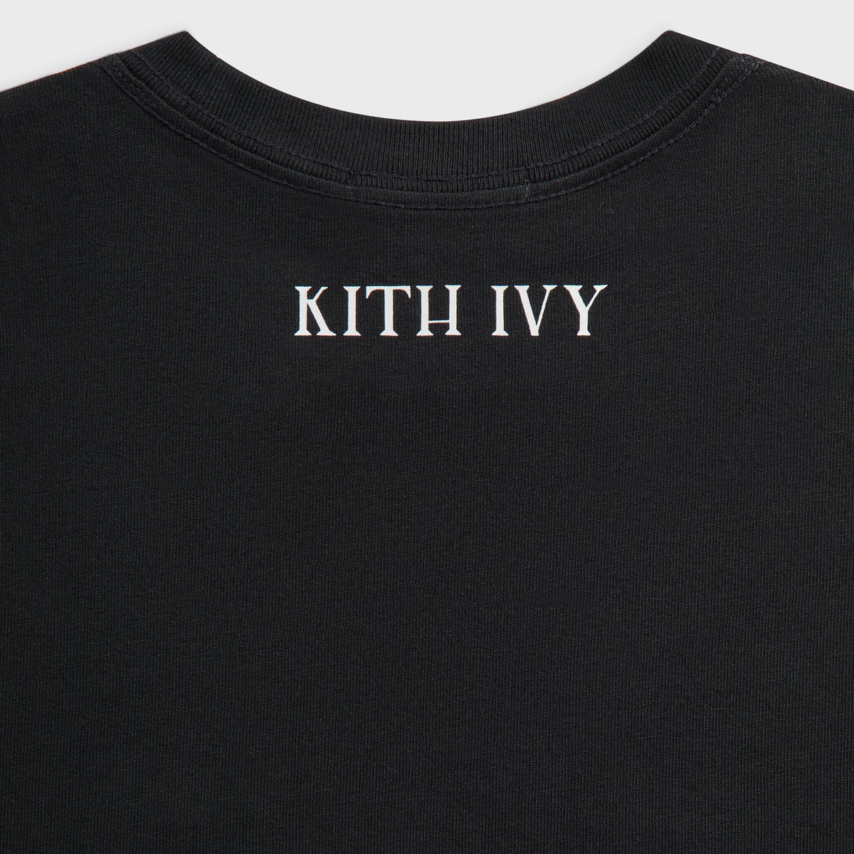Close-up of black Kith Ivy Classic Logo Tee back neck with cream KITH IVY print and ribbed collar