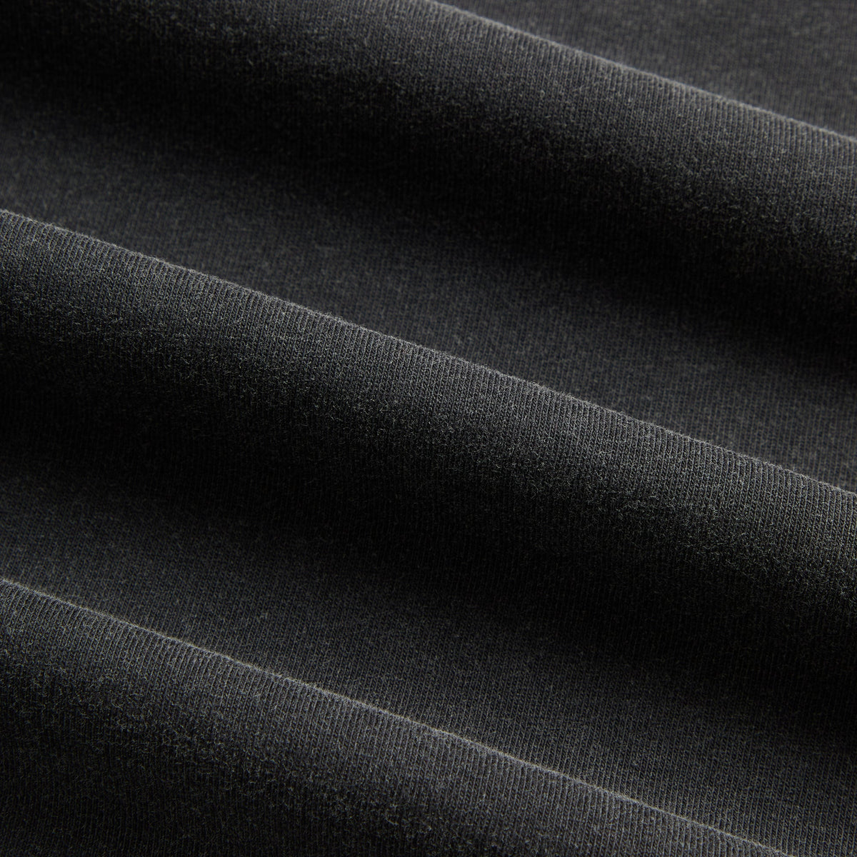 Close-up of washed black cotton jersey fabric texture, Kith for Friday the 13th Blood Mask Vintage Tee