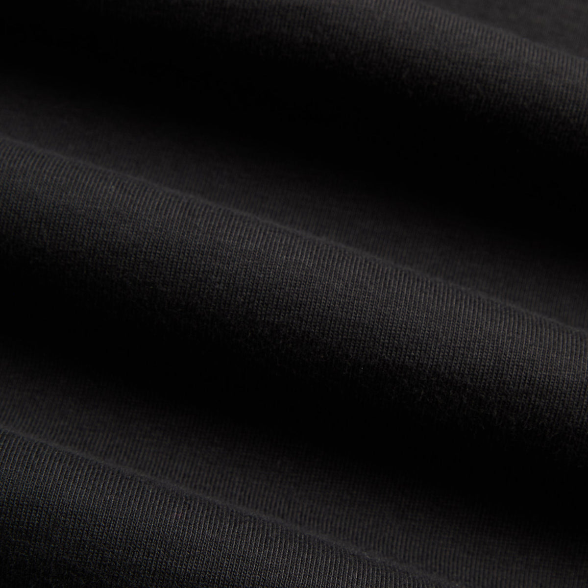 Close-up of black cotton jersey fabric texture, Kith for Friday the 13th Freddy vs Jason Vintage Tee