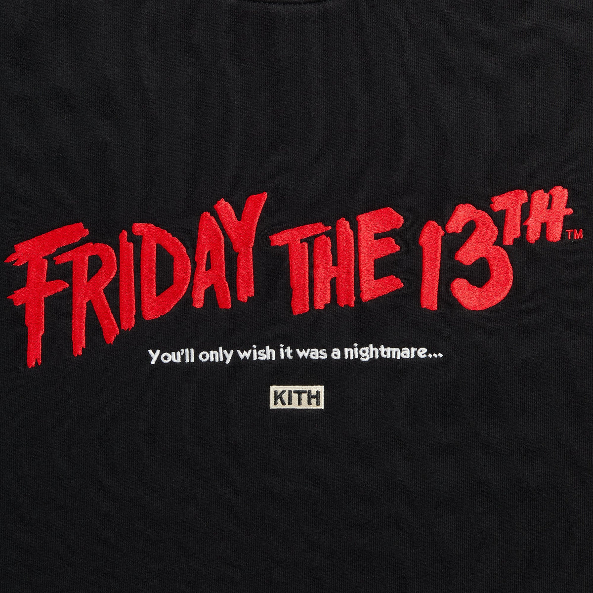 Close-up of red Friday the 13th embroidery, white tagline and Kith box logo on Headline Nelson Crewneck in black