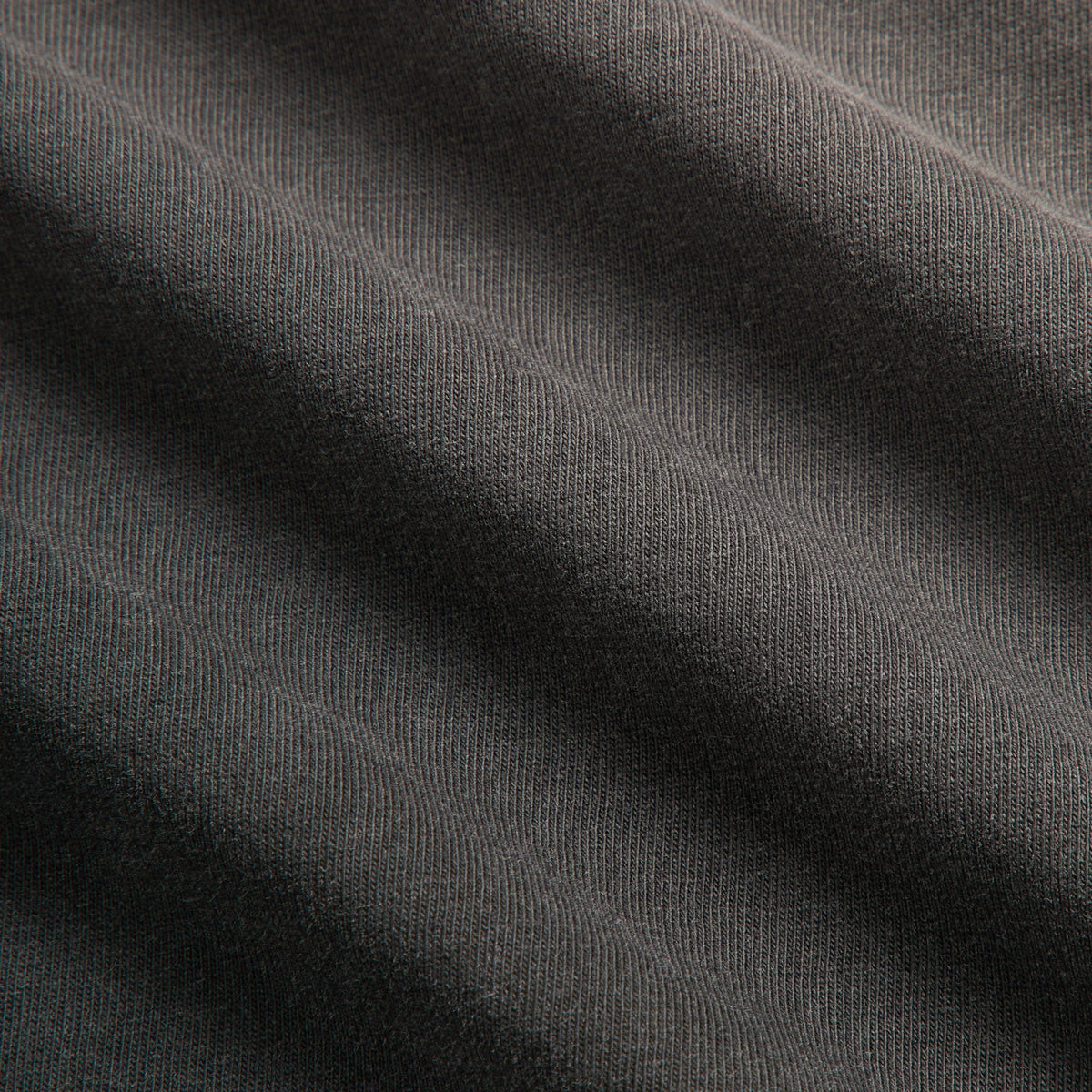 Close-up of washed black cotton jersey fabric texture on the Kith Vancouver Grizzlies Vintage Jones II tee