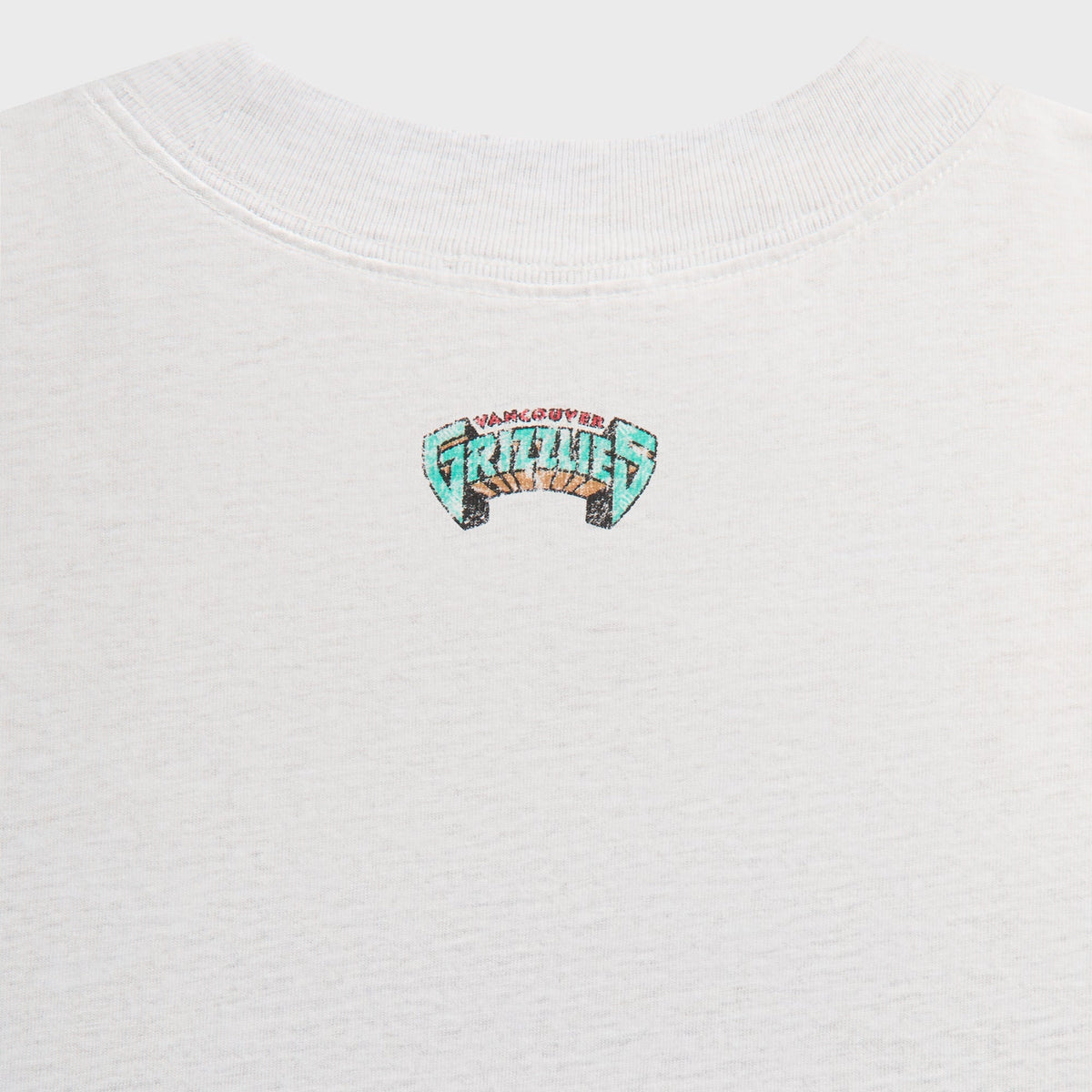 Kith for the Vancouver Grizzlies Vintage Jones II Tee close-up of small teal Grizzlies logo at the back neck on light heather grey