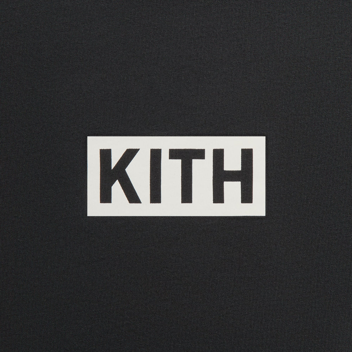 Close-up of white Kith box logo printed on the chest of the black Vancouver Geometric long sleeve tee