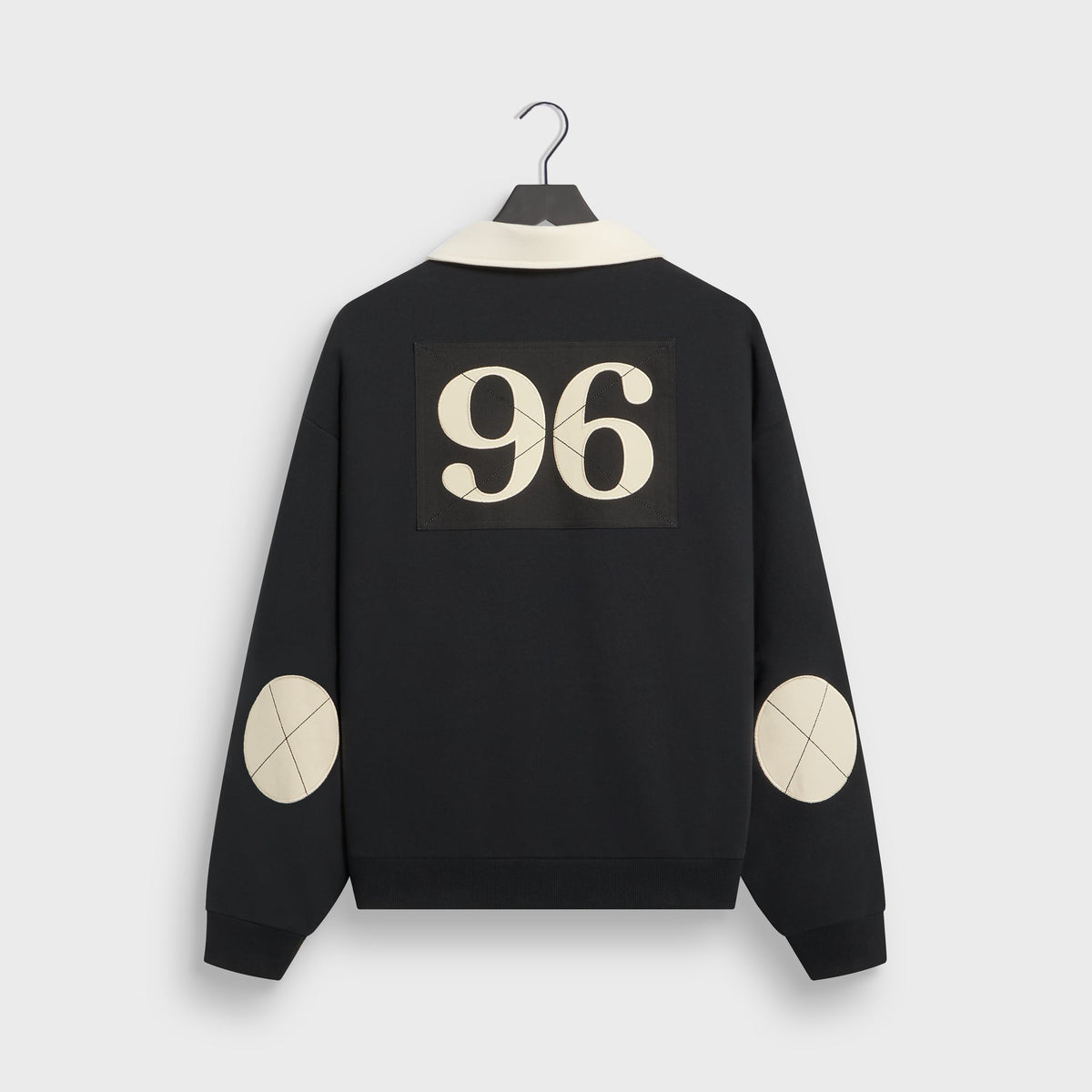 Kith Vancouver Nelson Rugby in black, back view with cream 96 patch and cream elbow patches on the sleeves