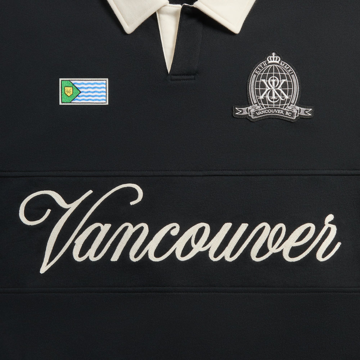 Kith Vancouver Nelson Rugby close-up of cream collar, Vancouver flag patch, crest badge and script Vancouver embroidery