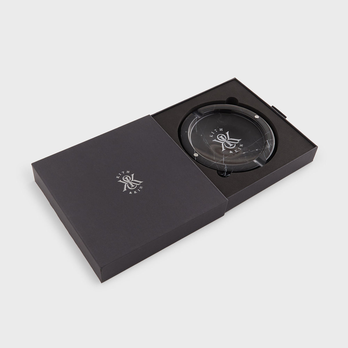 Kith Marble Catchall Tray in black marble nested inside its open dark Kith & Kin gift box