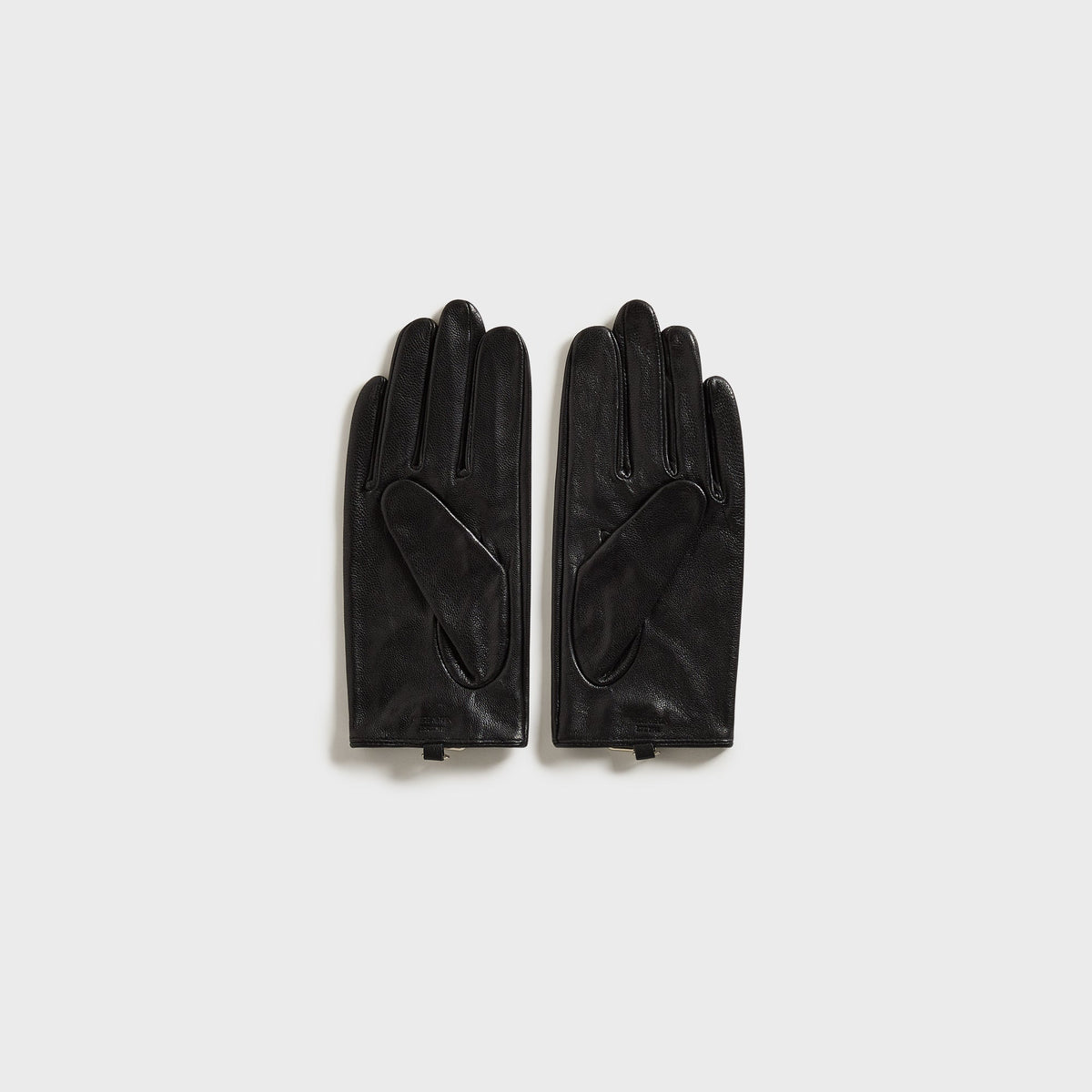 Kith Women cut-out fitted gloves in black leather with teardrop cut-out on the back of the hand, flat-lay view