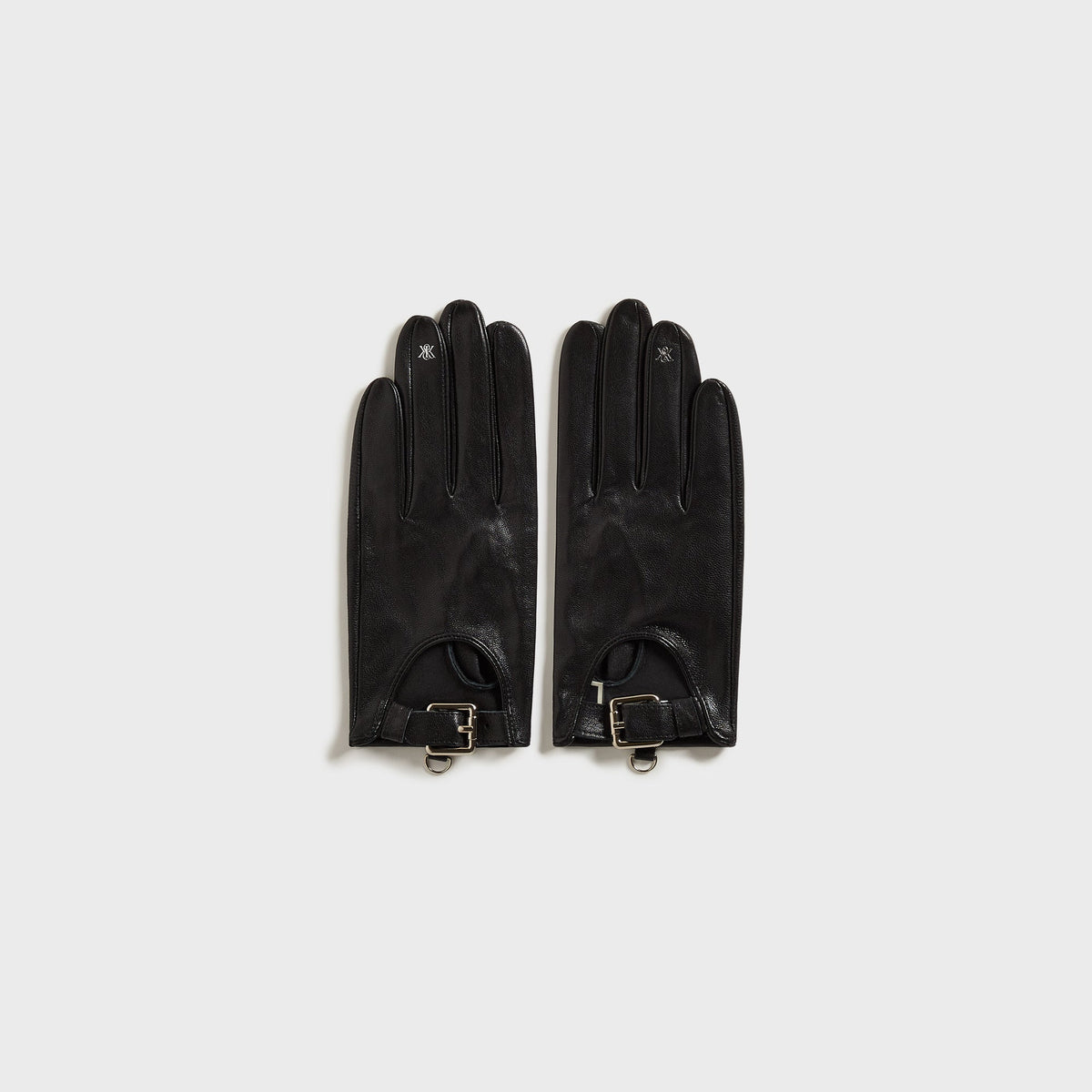 Kith Women cut-out fitted gloves in black leather with wrist buckle strap, palm-side flat-lay view