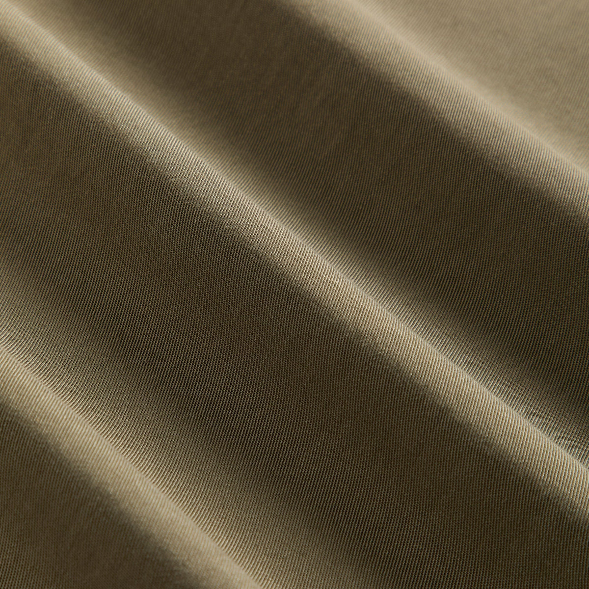 Close-up of the olive Chelonian twill fabric texture on the Kith Women Tallis waist strap trouser