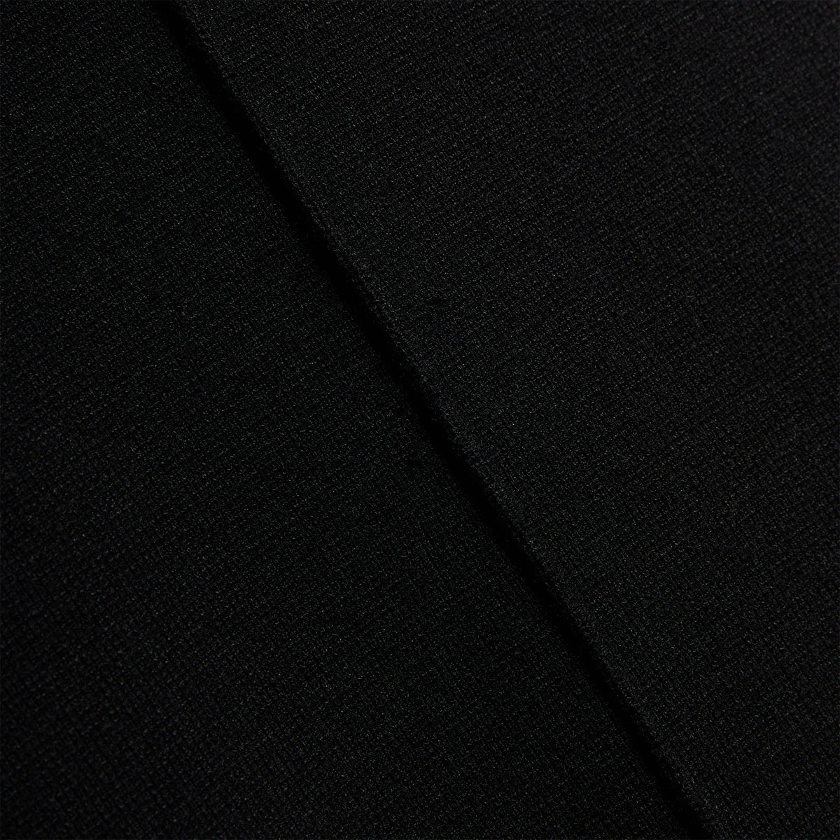 Close-up of the ribbed knit fabric texture on the black Kith Piper II Sleeveless Mini Dress