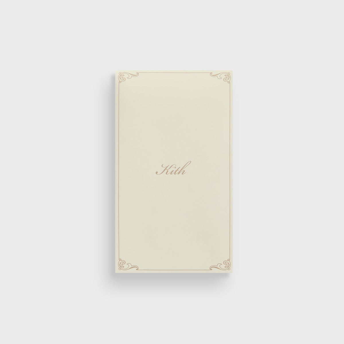 Kith branded packaging card in cream with gold scroll border and 'Kith' script logo