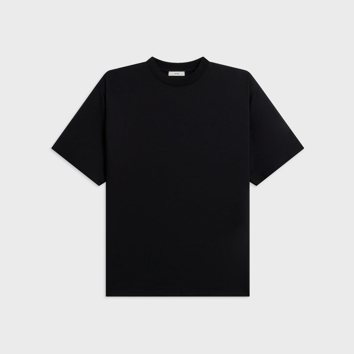 ATON Royal Wool Jersey Loose Fit Long Sleeve Tee in black, front view with crew neck and boxy shoulders