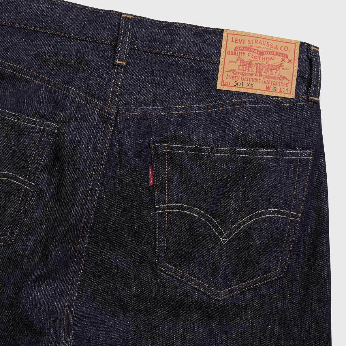 Levi's 1955 501 Original Selvedge Jean in dark indigo, close-up of back pocket, red tab and leather-look patch
