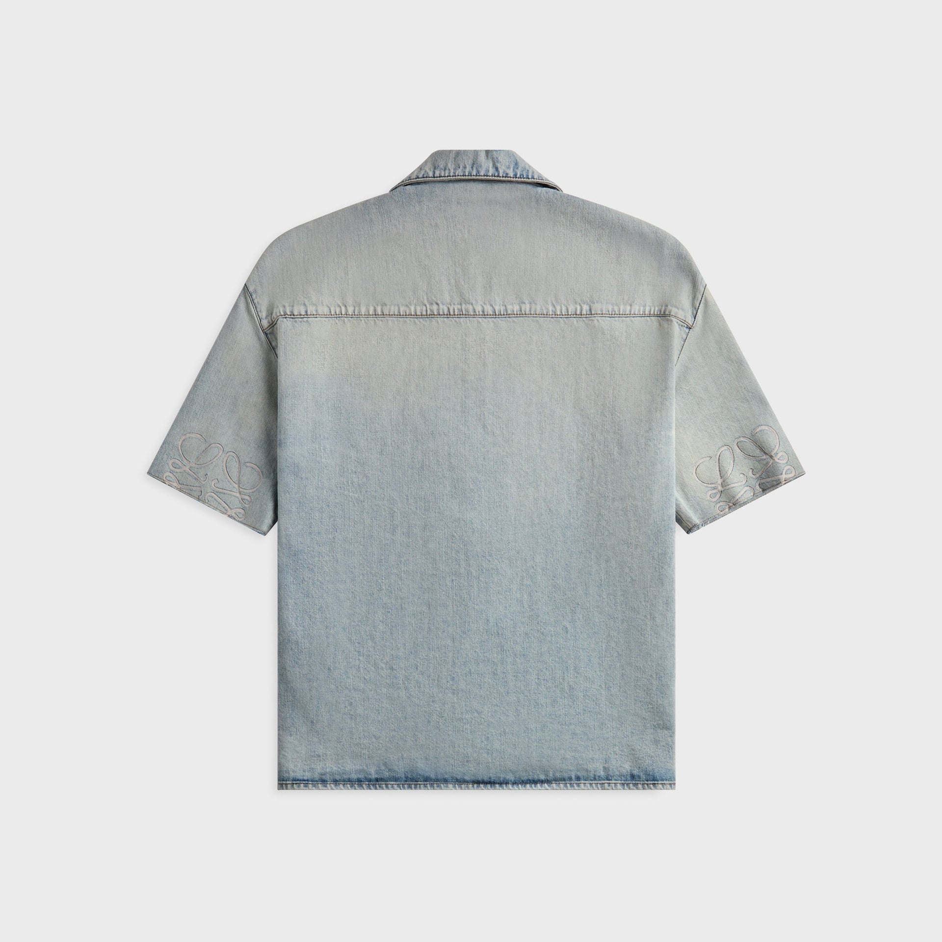 Loewe washed blue denim shirt, back view with tonal Anagram embroidery on both short-sleeve hems