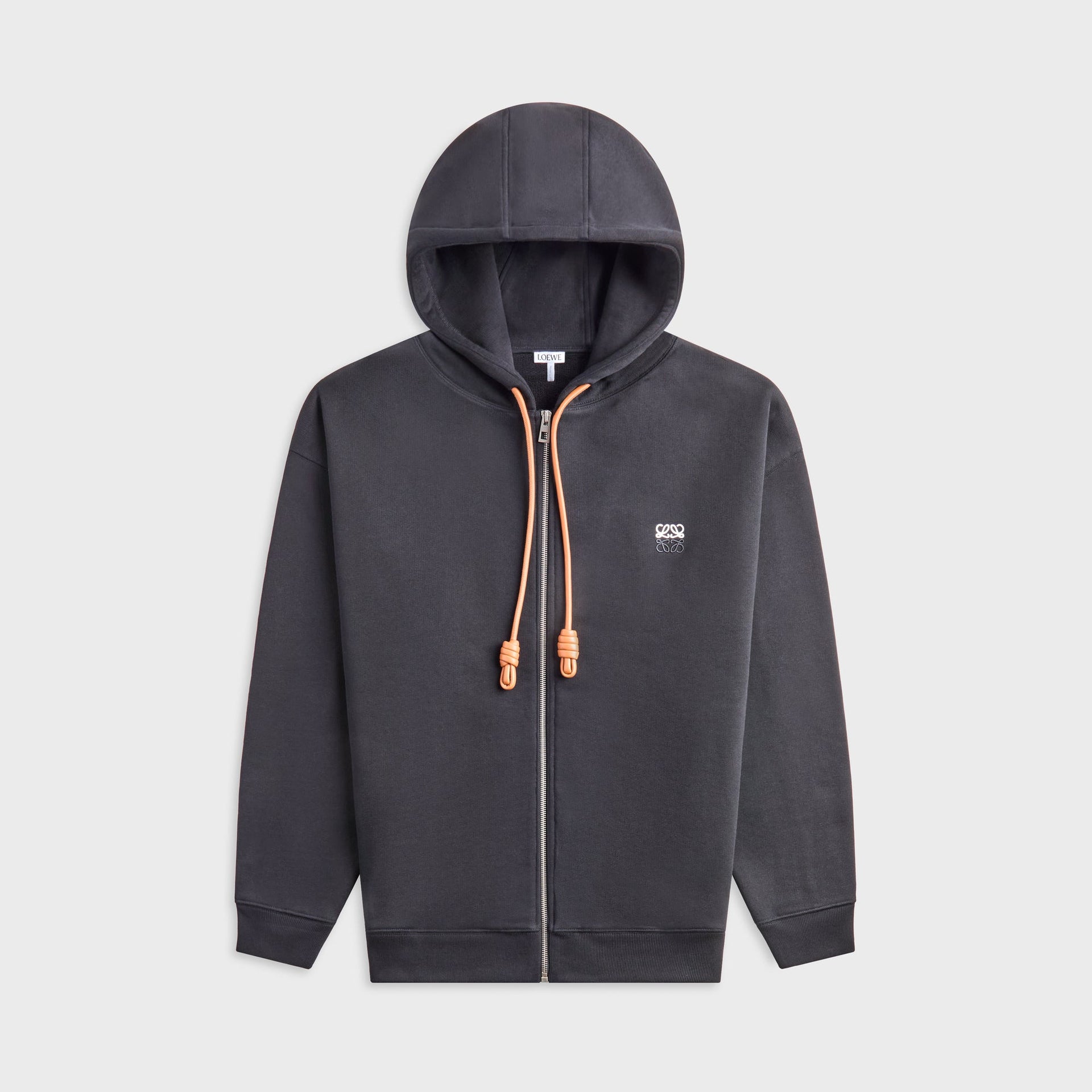 Loewe zip-up hoodie in washed black, front view with tan leather knotted drawcords and white chest Anagram