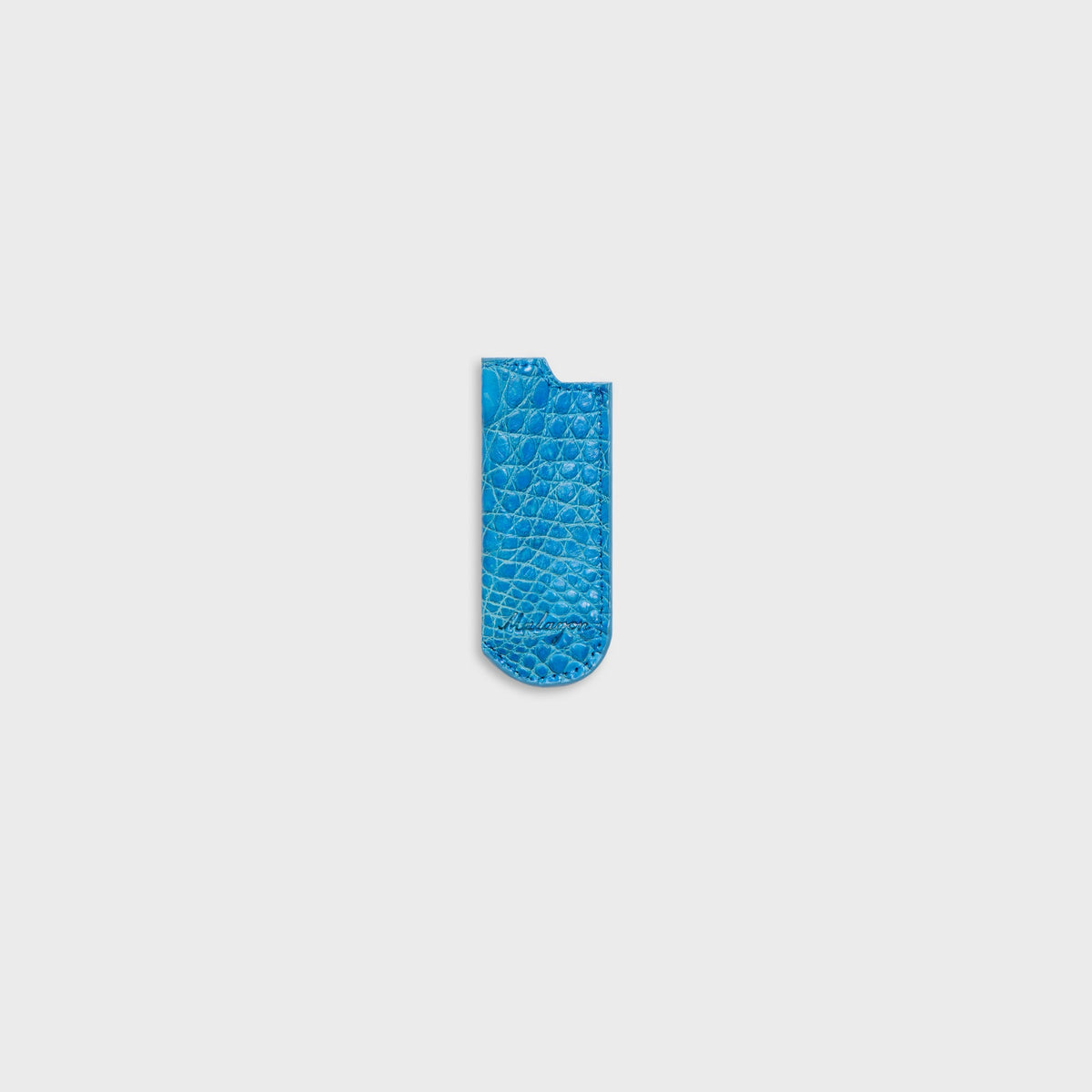 Malagon croc-embossed lighter cover in baby blue, small-scale croc texture and Malagon script