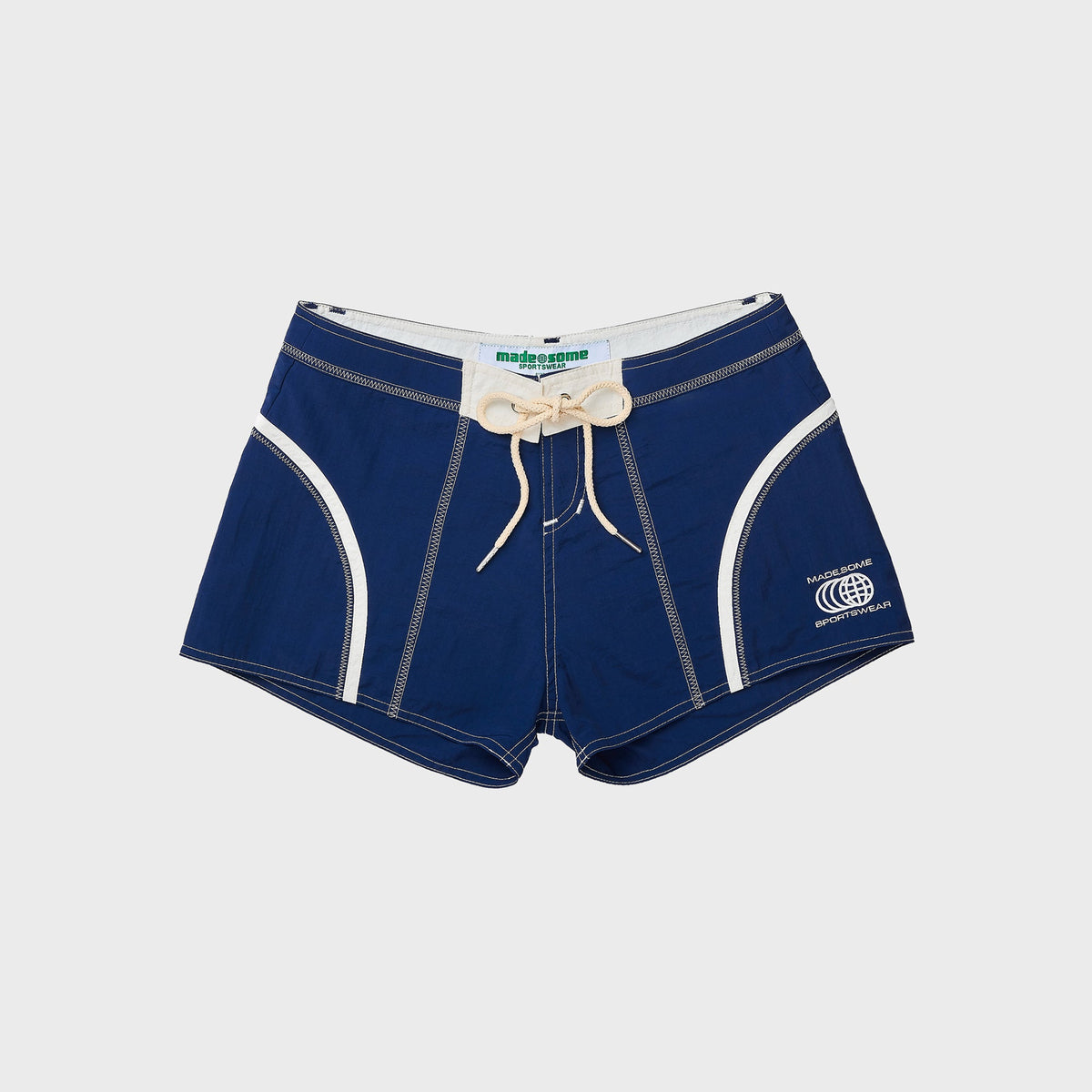 Made Some Short Shorts in Navy: low-rise navy nylon shorts with white curved trim, cream drawcord and Made Some logo, front