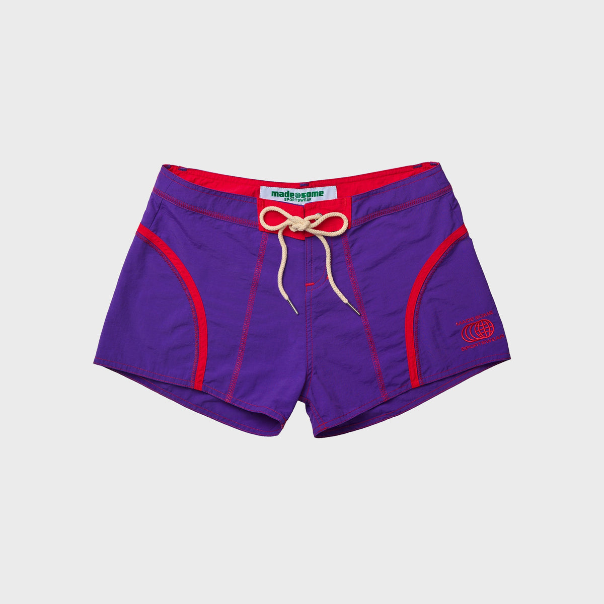 Made Some Short Shorts in Purple: low-rise nylon shorts with red curved trim, cream drawcord and embroidered globe logo, front