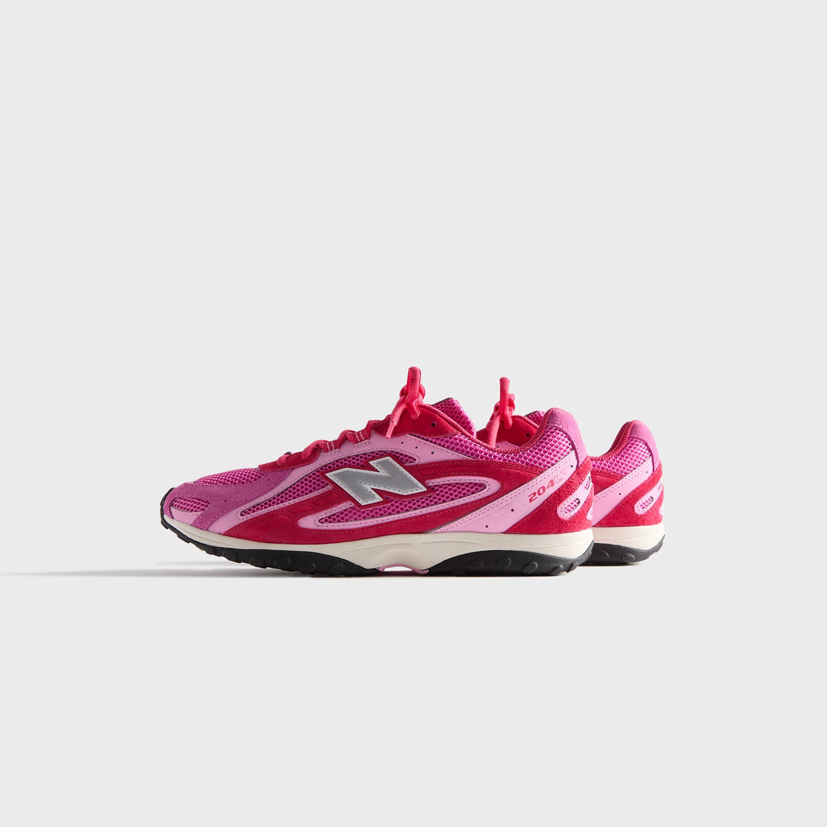 Kith & New Balance 204L in Camellia, medial side profile of the single sneaker with inner N logo and pink mesh