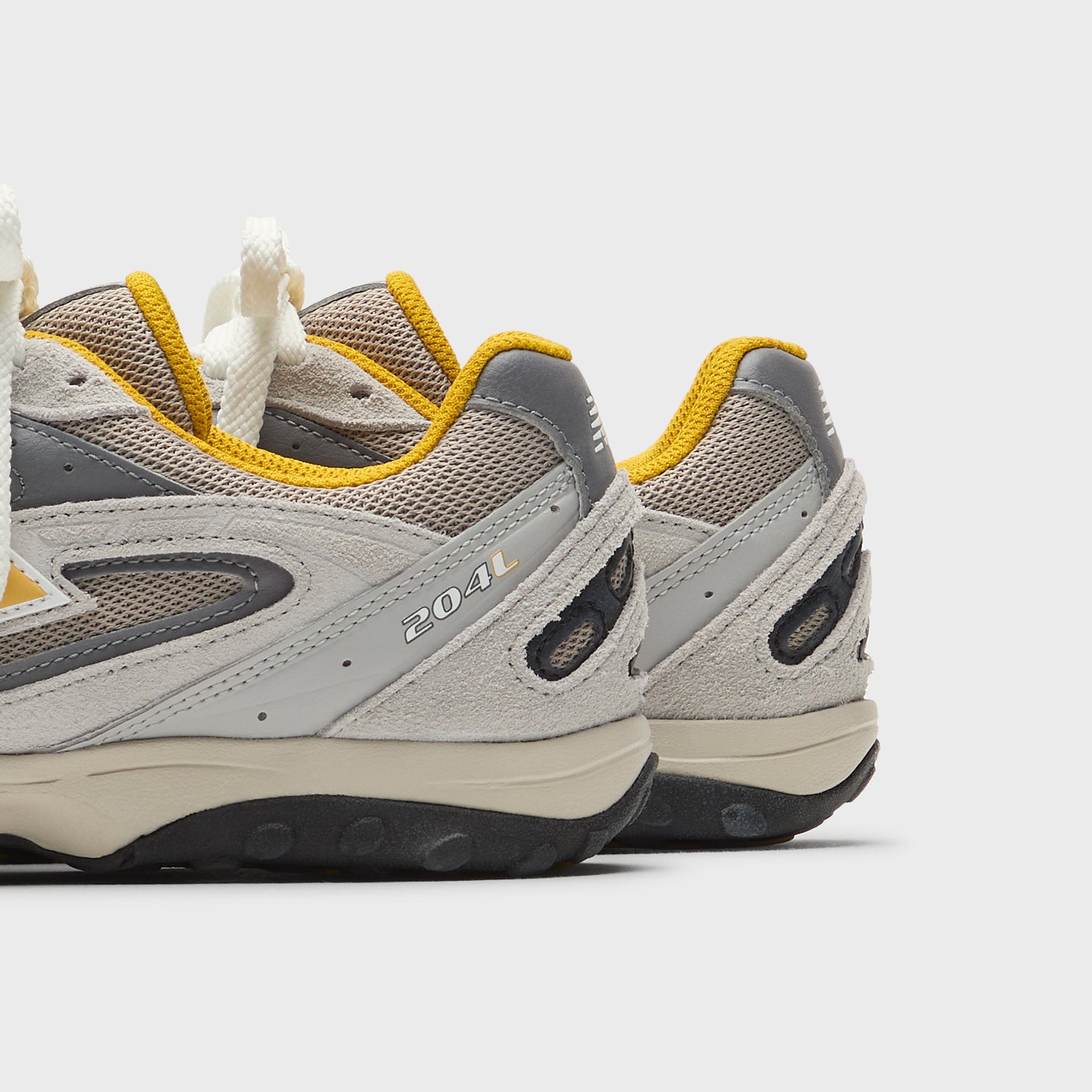 Kith x New Balance 204L sneaker, grey suede heel detail with yellow accents and 204L branding