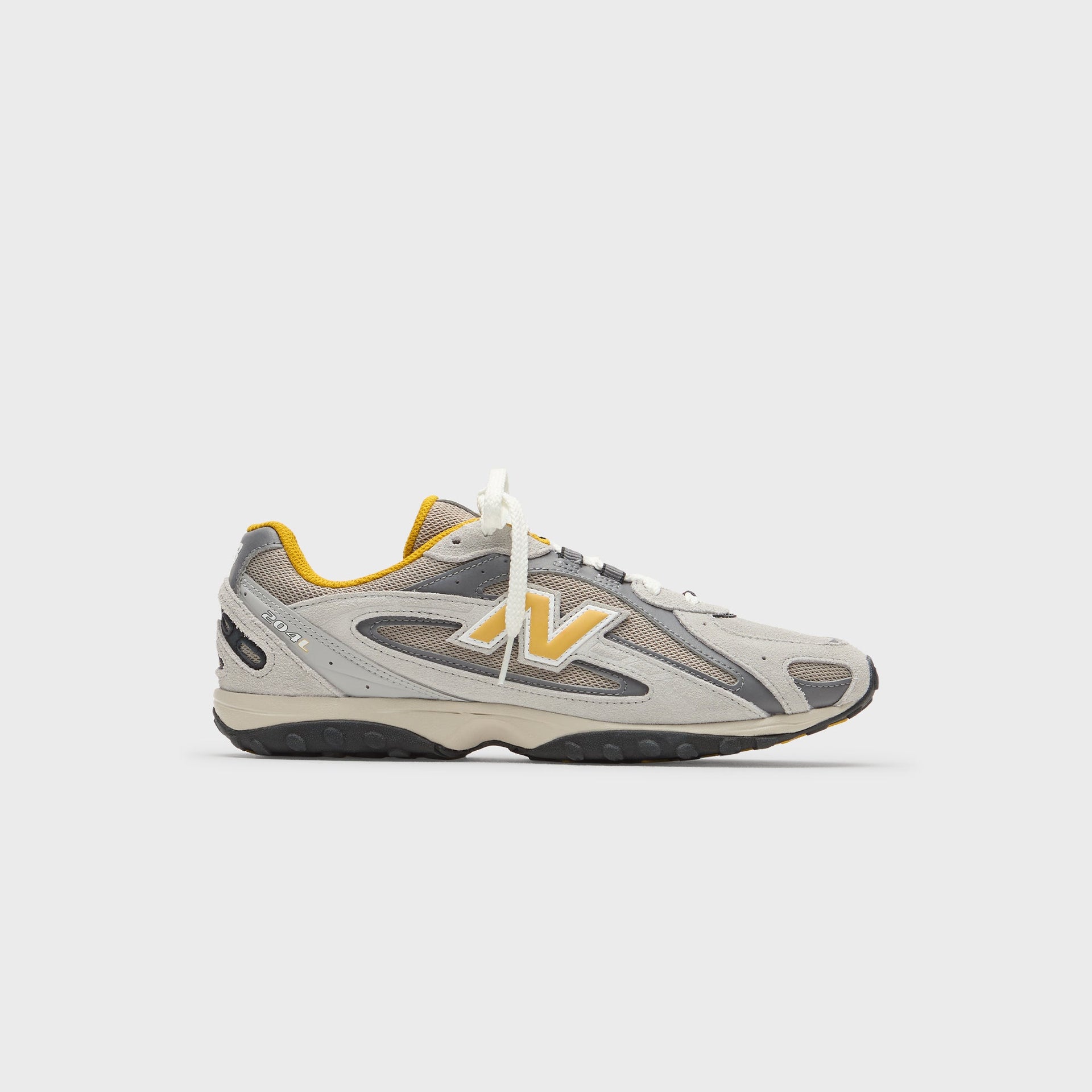 Kith x New Balance 204L sneaker, full lateral side profile in grey suede and mesh with yellow N logo