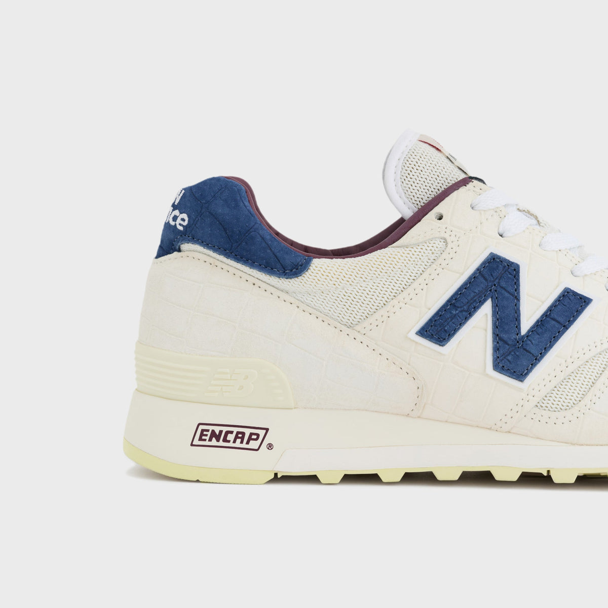 New Balance Made in USA 1300 sneaker in Angora, close-up of the Blue Oyster suede N logo and ENCAP branding at the heel