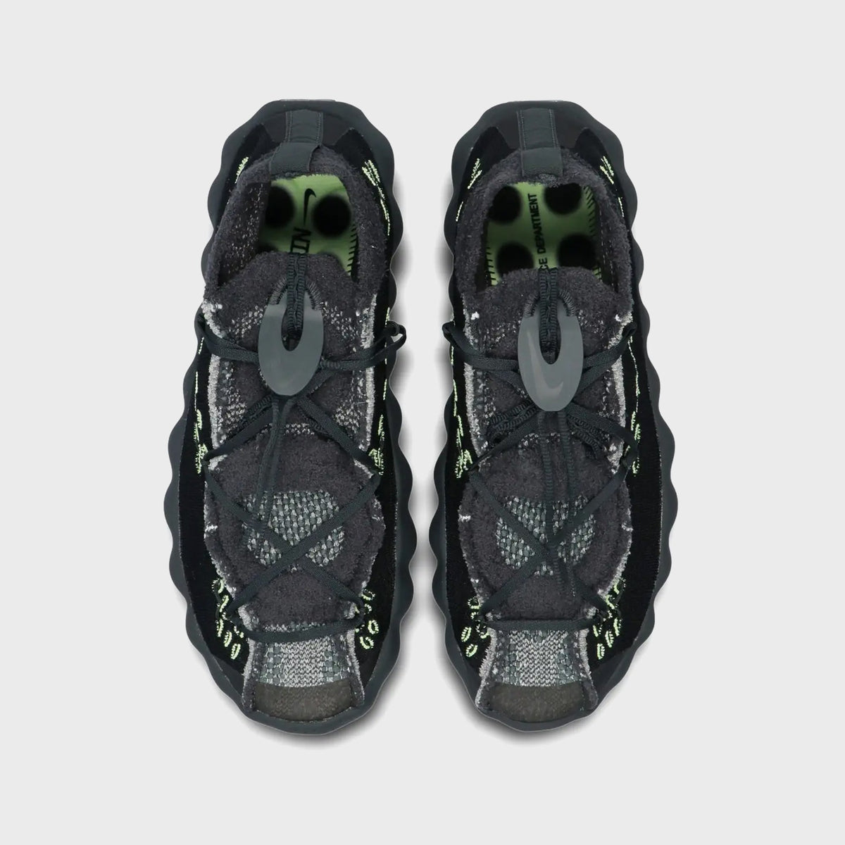 Top-down view of pair of Nike Mind 002 Flyknit in black and dark smoke grey with bungee lacing and lace toggle