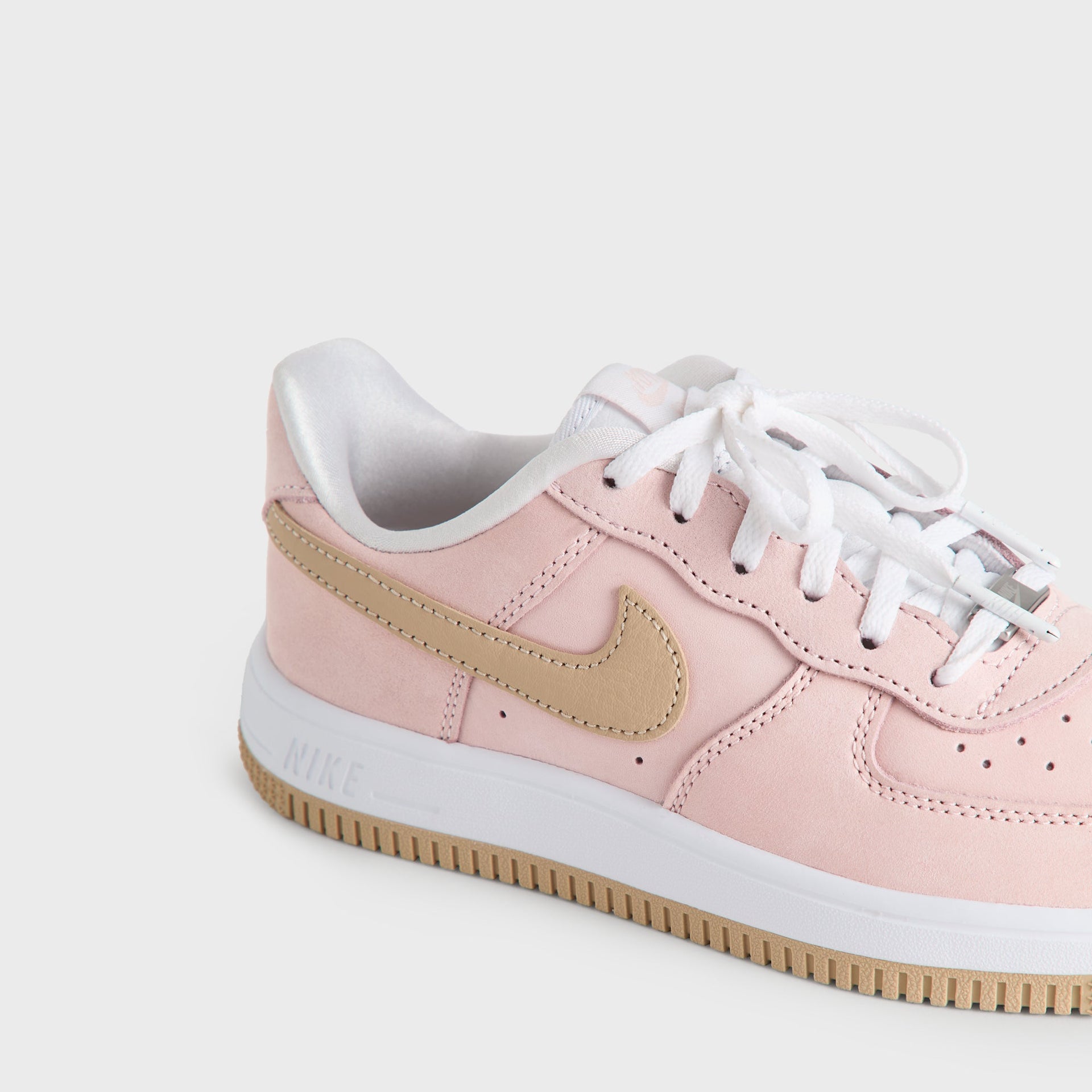 Top-down close-up of the Kith Kids x Nike PS Air Force 1 Un-Linen white laces and perforated pink toe