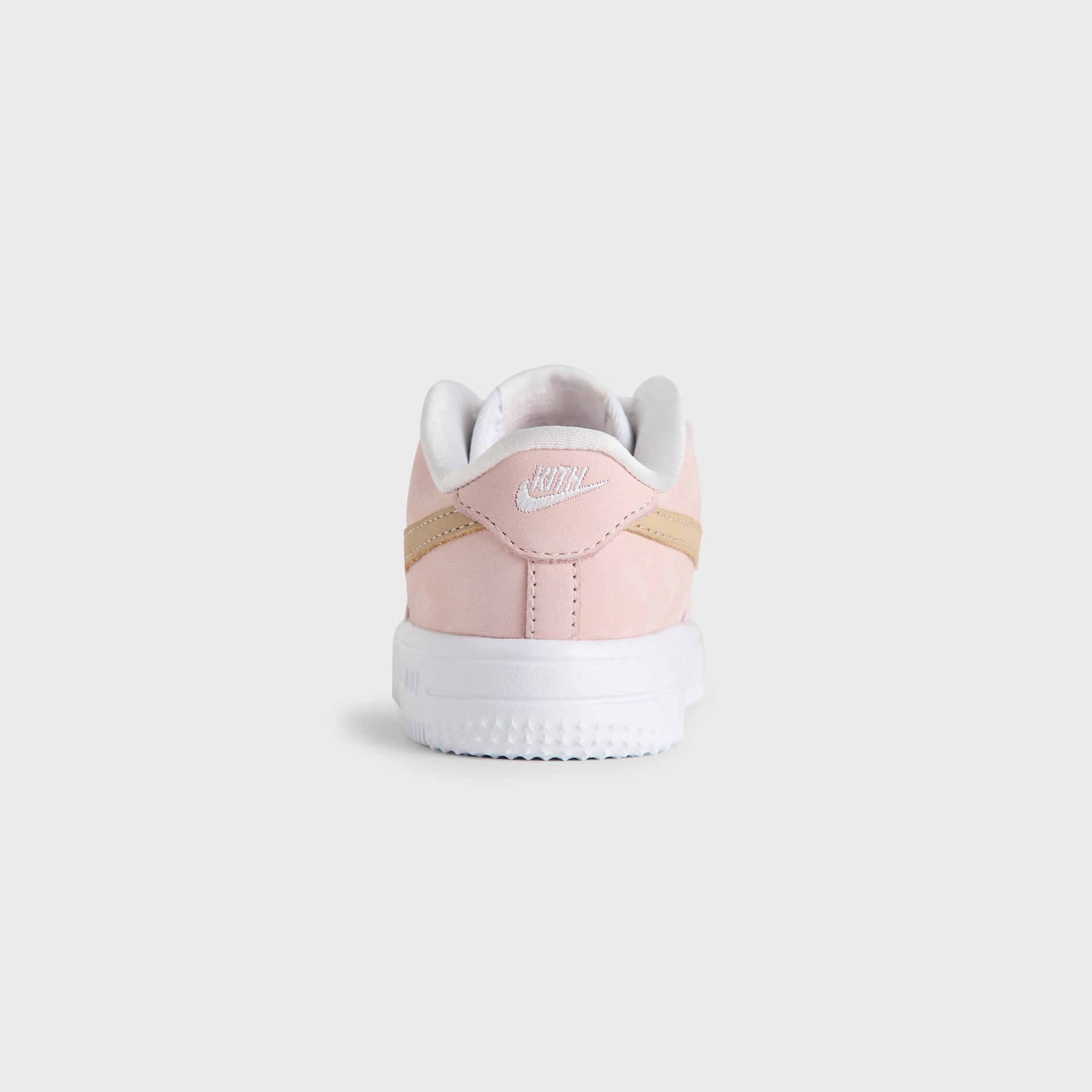 Heel view of the Kith Kids x Nike TD Air Force 1 Un-Linen in Atmosphere pink with a white Nike heel logo