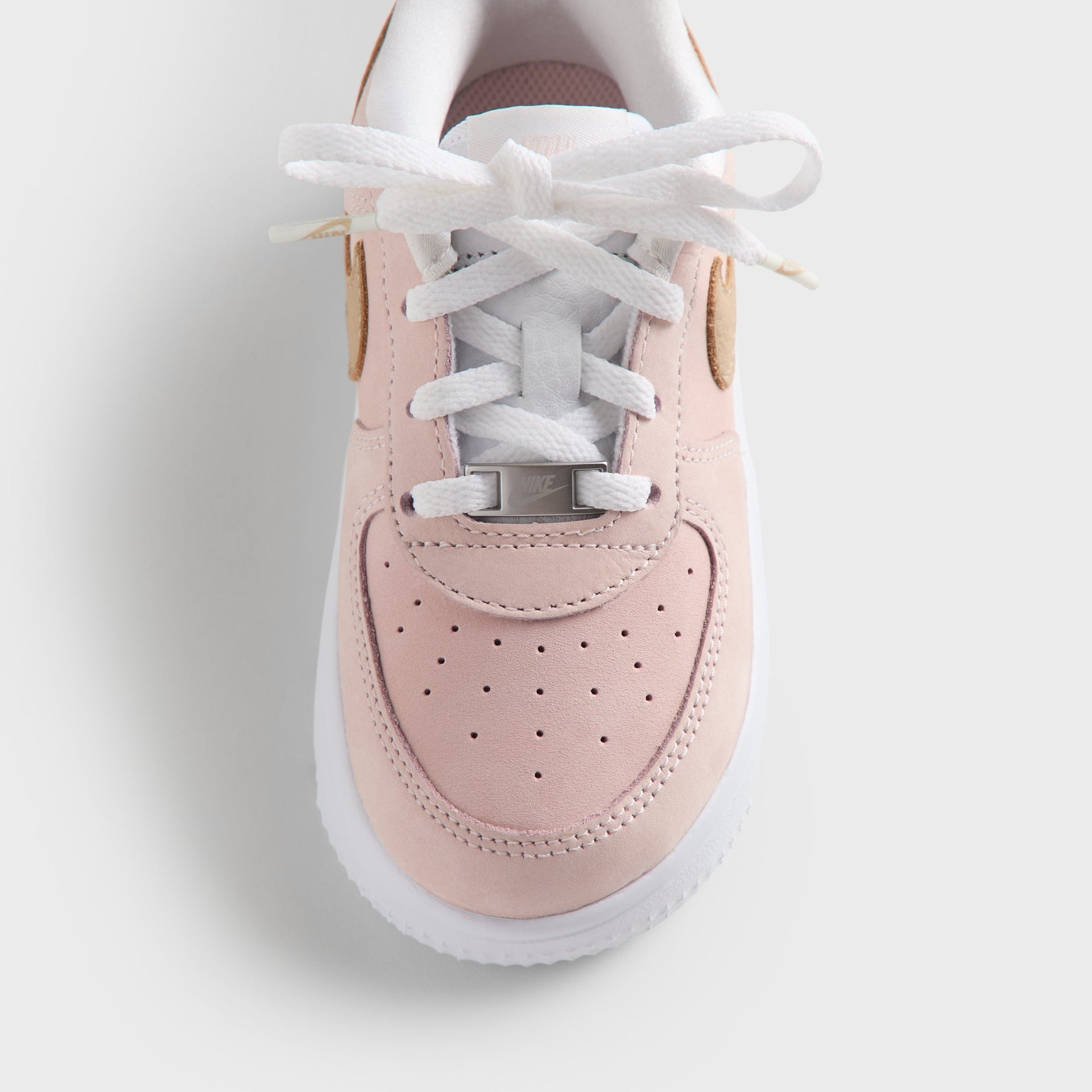 Close-up of the Kith Kids x Nike TD Air Force 1 Un-Linen toe box, wheat suede Swoosh and white sole