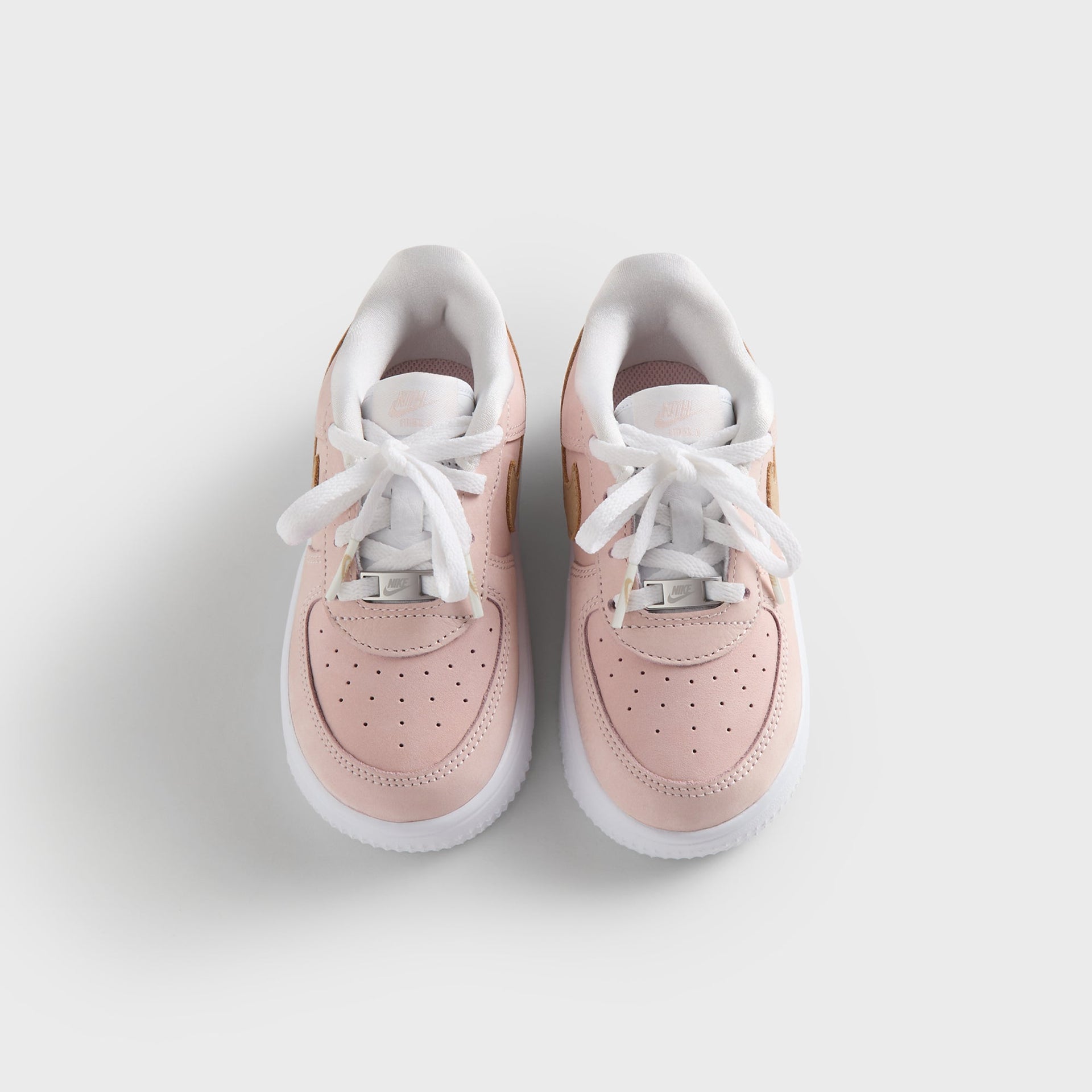 Kith Kids x Nike TD Air Force 1 Un-Linen pair from above, pink uppers, white laces and wheat suede Swoosh
